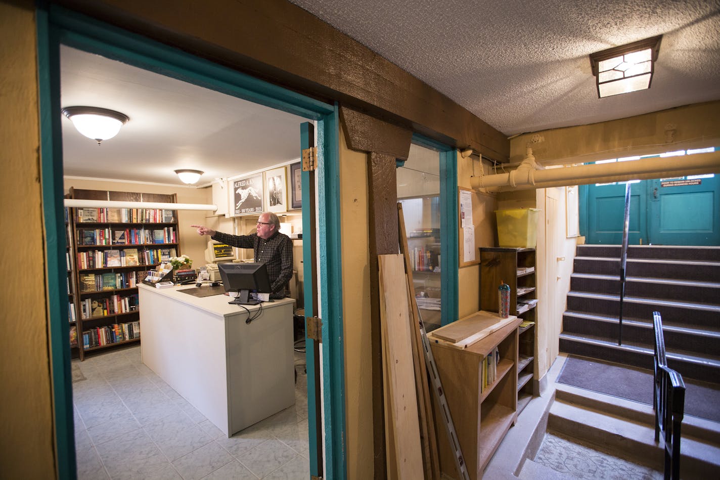 Owner Tom Bielenberg mans the front desk at Micawber's Books in their new smaller location just steps away from the old one.