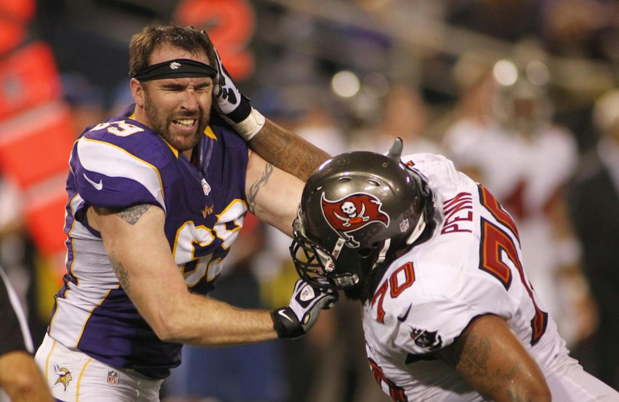 Vikings defensive end Jared Allen, left, gets in a tussle with Tampa Bay Buccaneers tackle Donald Penn.