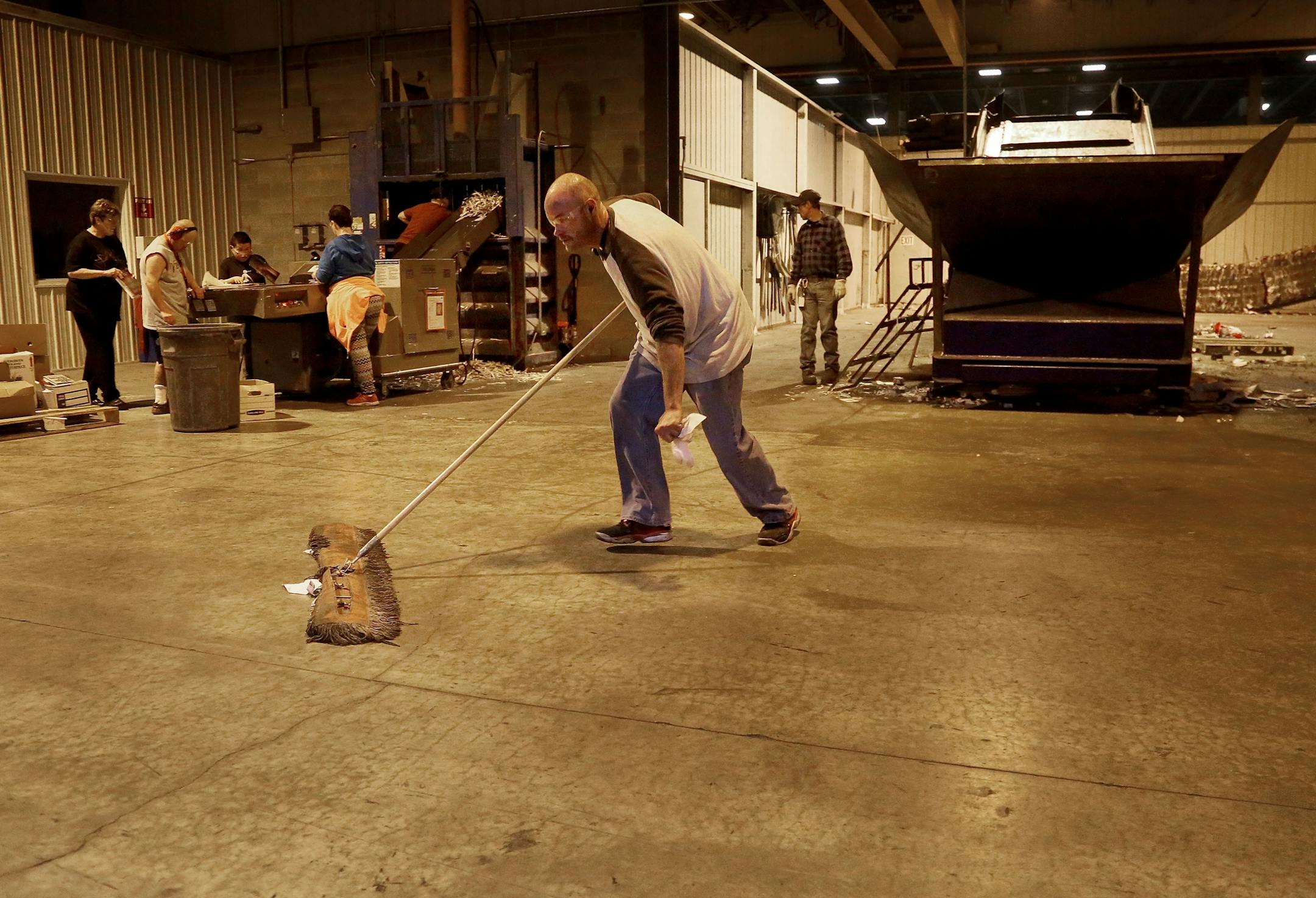 Disabled workers like John Week, 37, have opportunities that they never thought possible. Workers who once toiled for years in dead-end jobs are now making up to $14 an hour at an MRI facility and have opportunities for advancement. Here, Week, front, who does multiple tasks during his work day, keeps the floor clean Tuesday, Sept. 27, 2016, in Cohasset, MN.