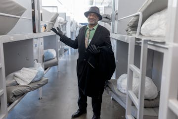 Roland Arnold, 71, who had been homeless since 2007, shows one of the beds he used to sleep in at Catholic Charities Twin Cities' St. Paul shelter on 