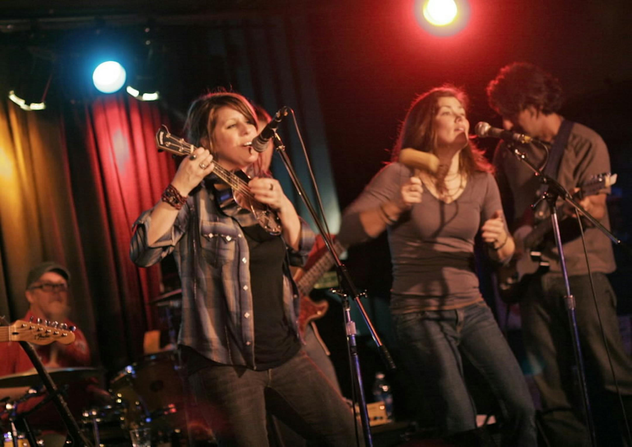 Molly Maher (center, playing the resophonic ukulele ) and her band, the Disbelievers performing at the Turf Club.