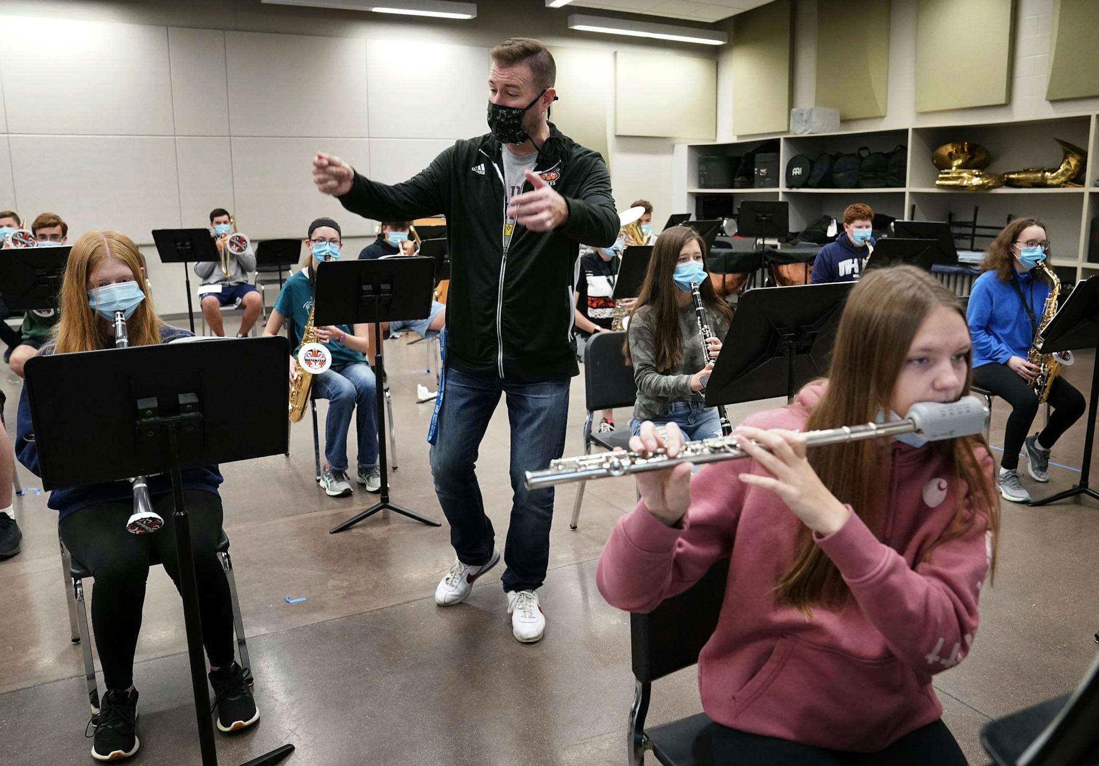 The pandemic has disrupted just about every part of school, but things are tough this year for band and choir programs but adjustments are making in person learning possible. Here, Bradley Mariska, associate director of bands, at Farmington High School, directs students during band class Thursday, at in Farmington. ] DAVID JOLES • david.joles@startribune.com Thursday, Sept. 17, 2020, in Farmington, MN. Band class for students at Farmington High -- pandemic style.**Bradley Mariska,cq