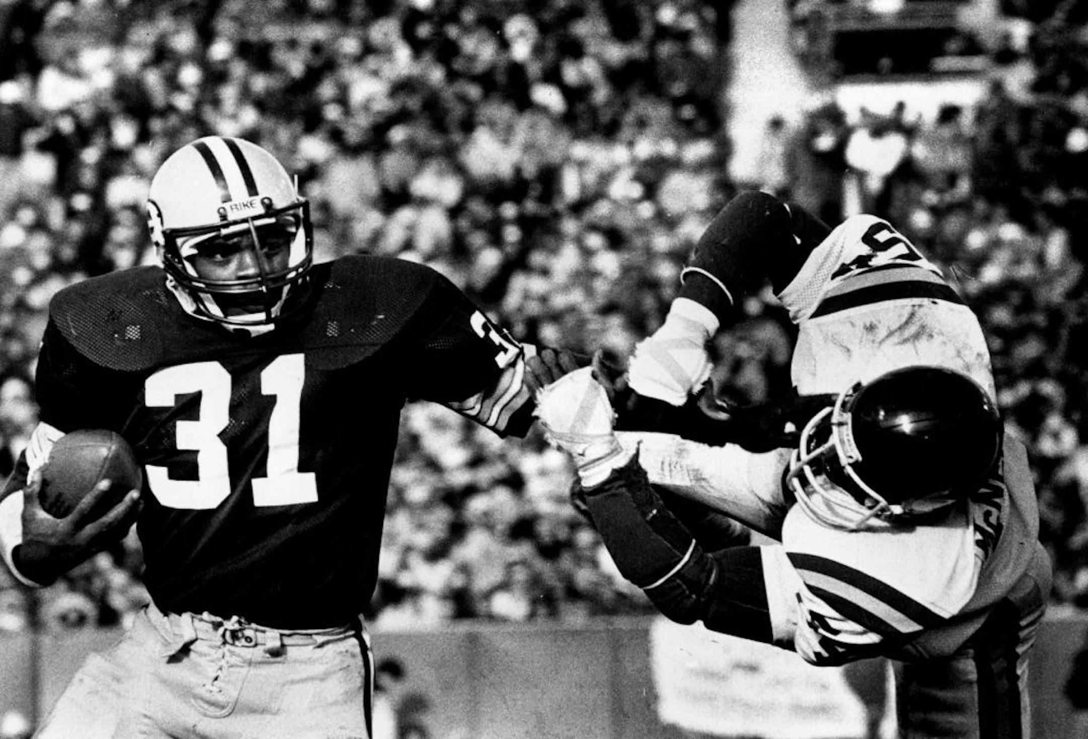 October 27, 1980 Green Bay fullback Gerry Ellis (31) stiff-armed Vikings linebacker Fred McNeill (54). Regene Radniecki, Minneapolis Star Tribune