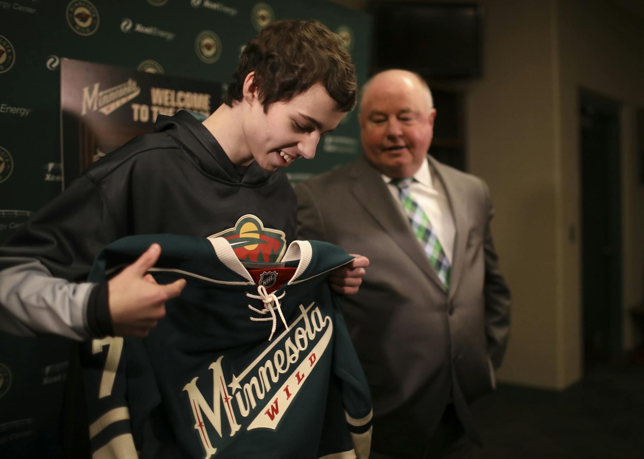 Carter Casey, 16, got ready to put on a Wild team sweater after it was presented to him by Minnesota Wild head coach Bruce Boudreau after Casey signed a one-day contract to the team. ] JEFF WHEELER ï jeff.wheeler@startribune.com The Minnesota Wild faced the San Jose Sharks in an NHL hockey game Sunday evening, March 5, 2017 at Xcel Energy Center in St. Paul. Prior the game, Carter Casey was Make-A-Wish Minnesota's 5000th wish recipient when he was signed to a one-day contract by Wild head c