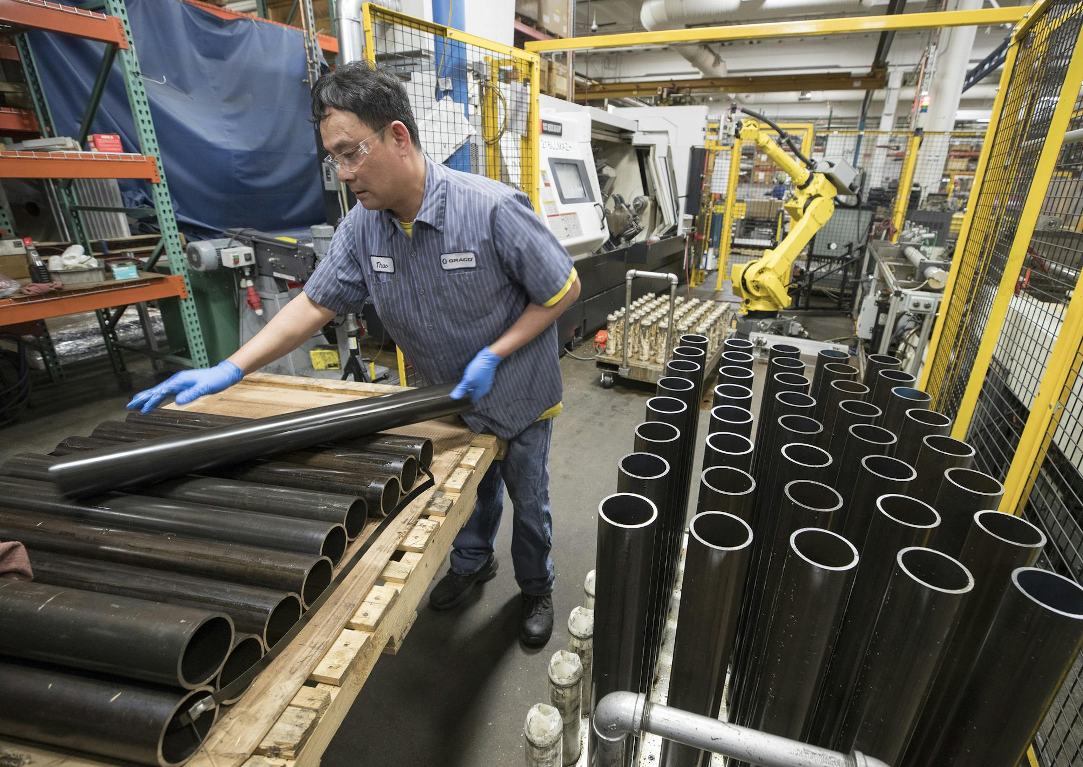 Thao Nguyen (cq) an employee at Graco, and stacked tubes of carbon steel Monday March 12, 2018 in Minneapolis, MN.] JERRY HOLT &#x2022; jerry.holt@startribune.com