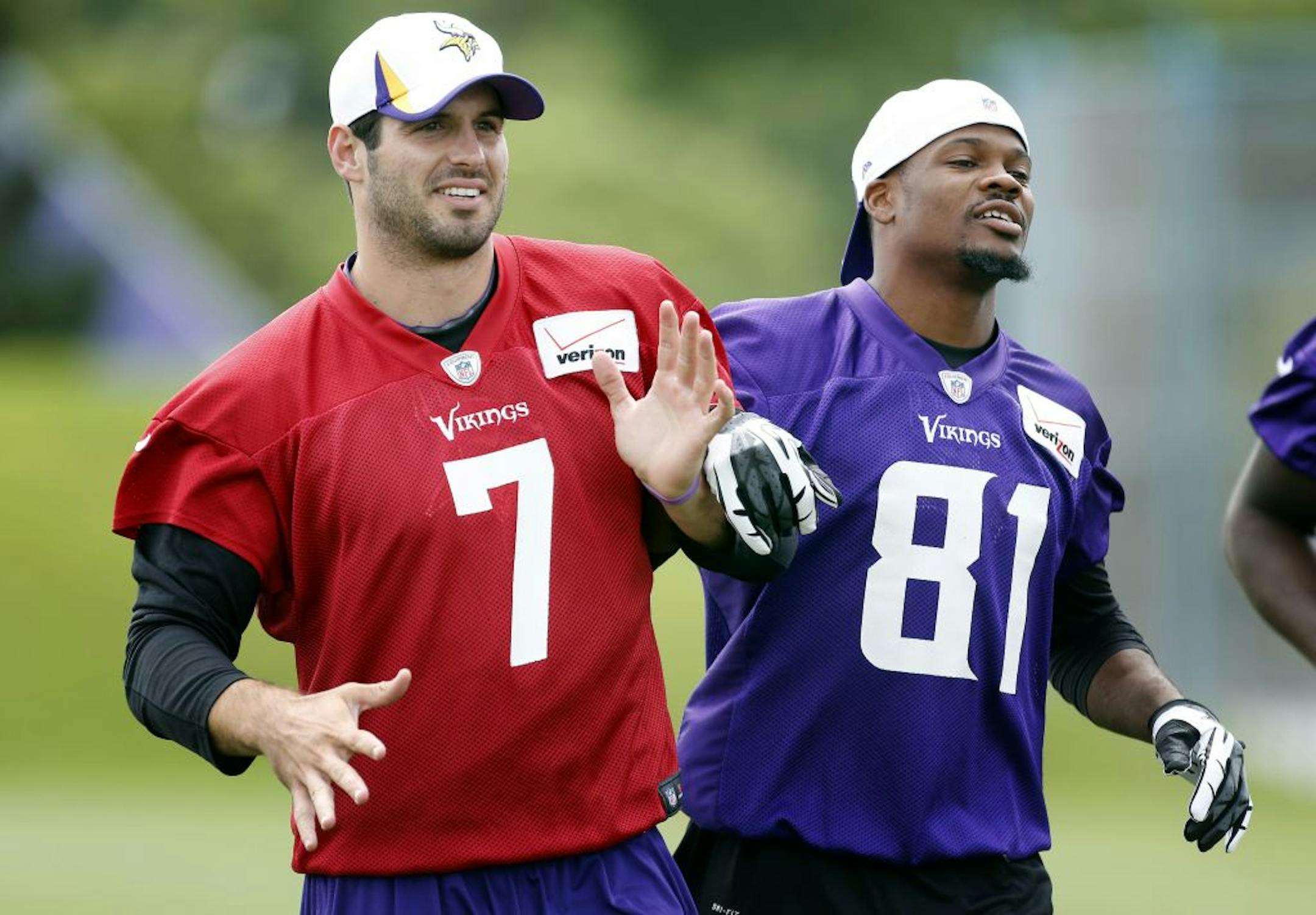 Vikings receiver Jerome Simpson (81) joked around with quarterback Christian Ponder (7) during morning practice on Friday.