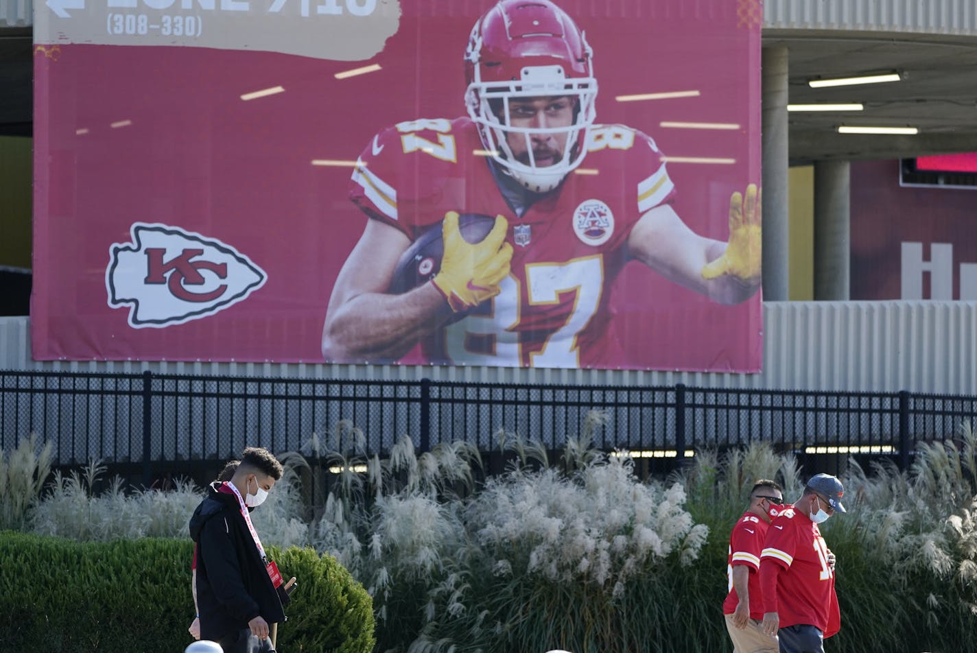 Fans wearing face masks arrive at Arrowhead Stadium before an NFL football game between the Kansas City Chiefs and the New England Patriots, Monday, Oct. 5, 2020, in Kansas City. (AP Photo/Jeff Roberson)