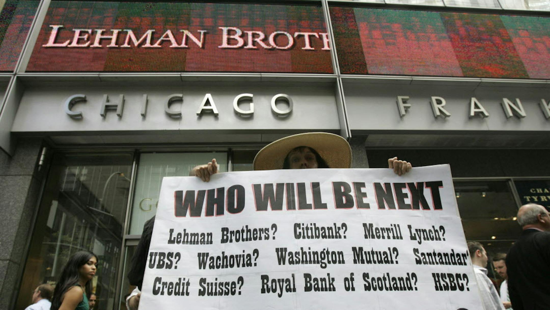** FOR USE SUNDAY, SEPT. 6 AND THEREAFTER ** FILE - In this Monday, Sept. 15, 2008 file photo, Robin Radaetz holds a sign in front of the Lehman Brothers headquarters in New York. That day, Lehman Brothers, a 158-year-old investment bank choked by the credit crisis and falling real estate values, filed for Chapter 11 protection in the biggest bankruptcy filing ever. (AP Photo/Mary Altaffer, file) ORG XMIT: MIN2013090915040965