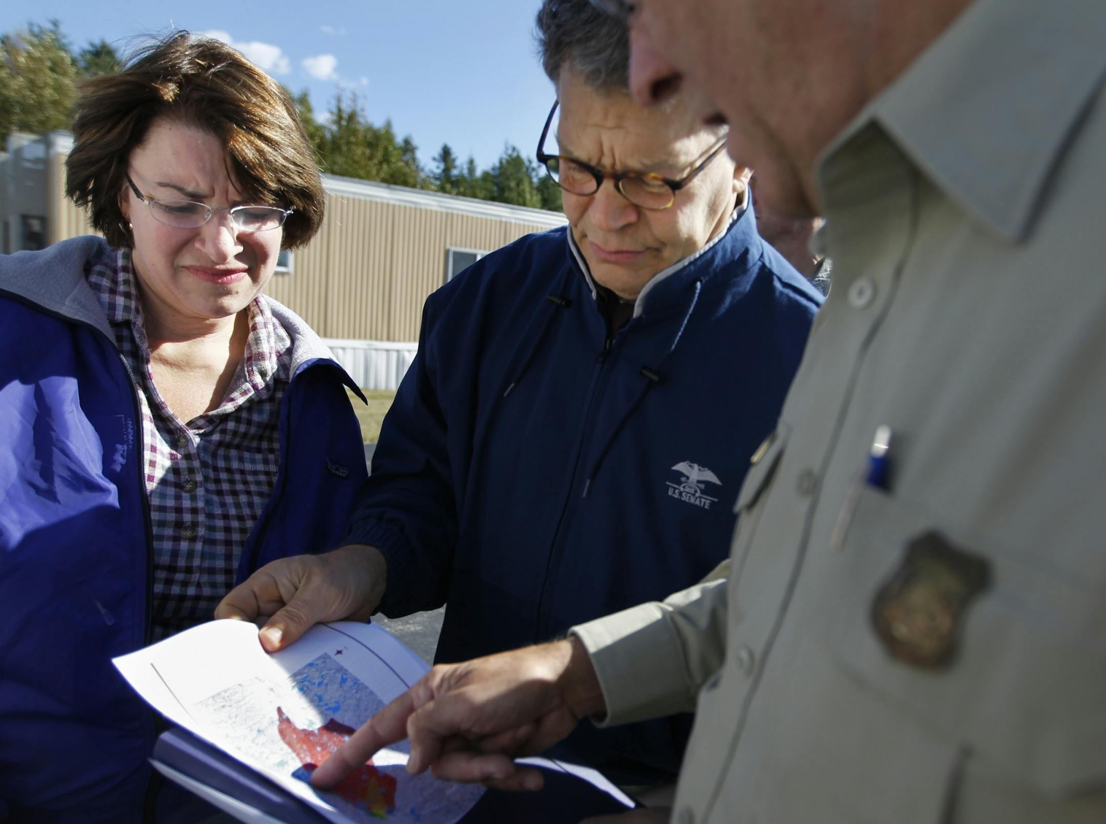 At the Ely Municipal Airport on Friday, Sept. 16, U.S. Sens. Amy Klobuchar and Al Franken got a rundown of the extent of the BWCA fires from Jim Sanders, the Superior National Forest Supervisor.