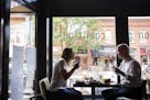 Jessica de Kozlowski, left, of Edina and Sean Curran of Minneapolis eat lunch at Coalition in downtown Excelsior on Wednesday, July 2, 2015. ] LEILA N