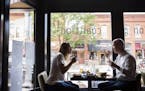 Jessica de Kozlowski, left, of Edina and Sean Curran of Minneapolis eat lunch at Coalition in downtown Excelsior on Wednesday, July 2, 2015. ] LEILA N