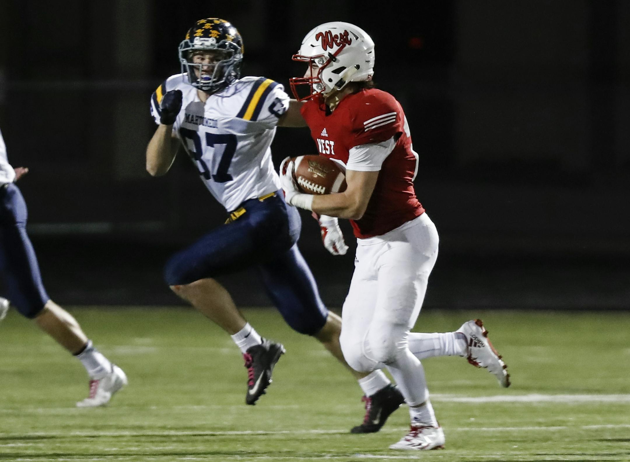 Mankato West's Thomas Yokiel (28) ran for a 81 yard touchdown after an interception in the final moment of the the first half during the Class 5A football quarterfinals Saturday, November 12, 2016, in Farmington Minn. Also pictured is Mahtomedi's Ryan Waldoch (87) ] RENEE JONES SCHNEIDER • renee.jones@startribune.com Between Mahtomedi and Mankato West.
