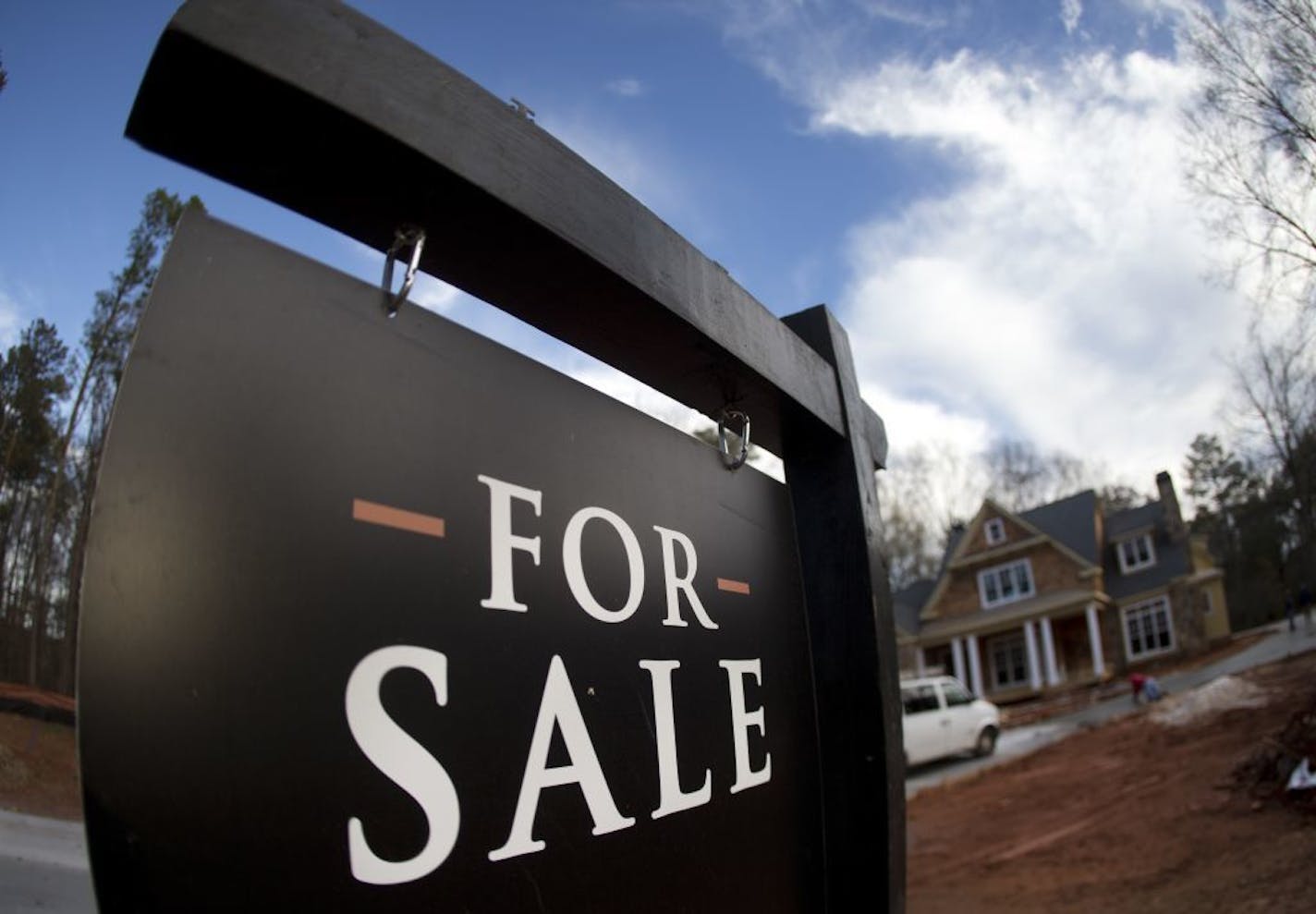 FILE - In this Thursday, Dec. 3, 2015, file photo, a home under construction and for sale is shown in Roswell, Ga. On Tuesday, Aug. 23, 2016, the Commerce Department reports on sales of new homes in July.