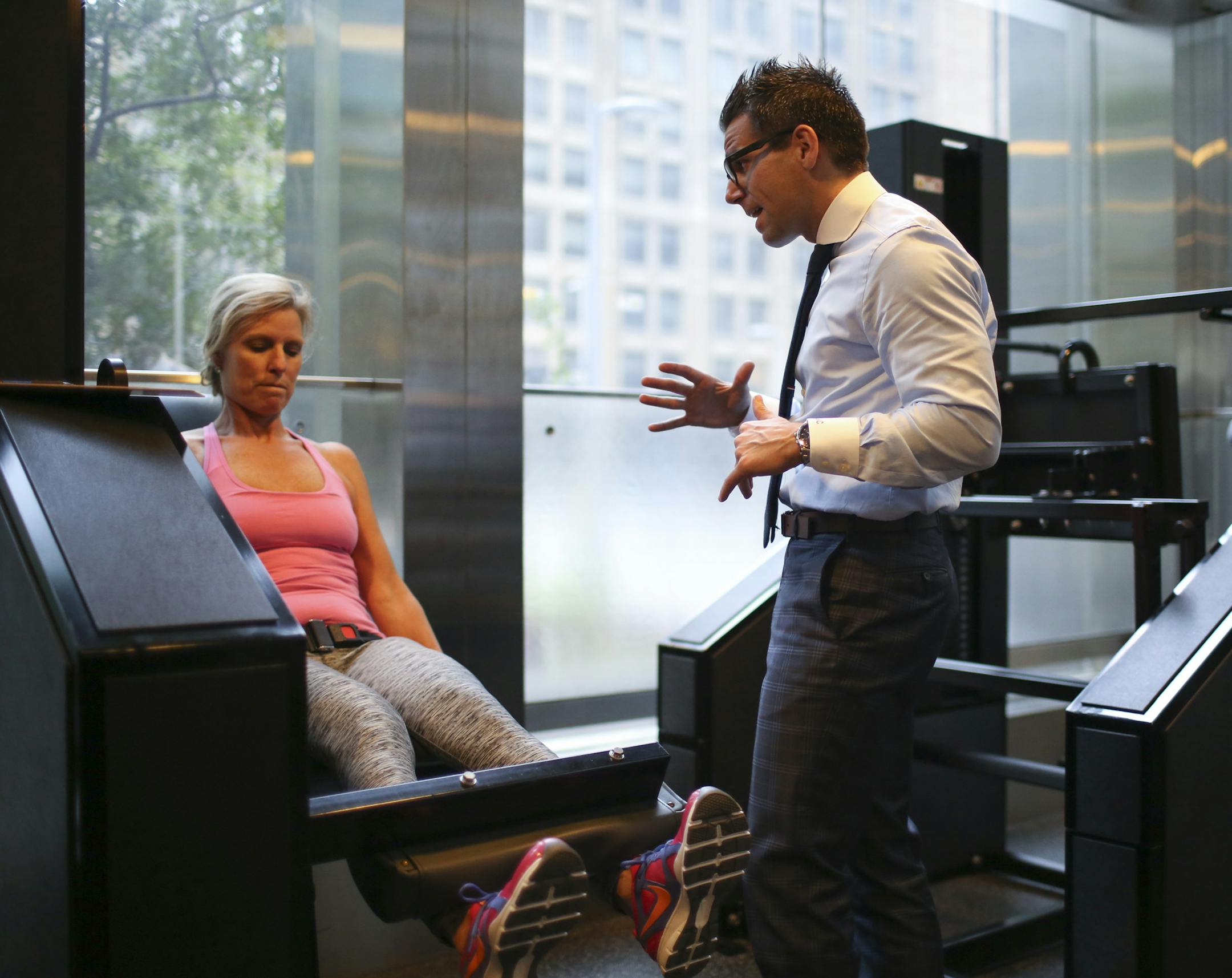 Luke Carlson, right, who founded Discover Strength 10 years ago, coached Teresa McFarland through her leg workout Wednesday afternoon.