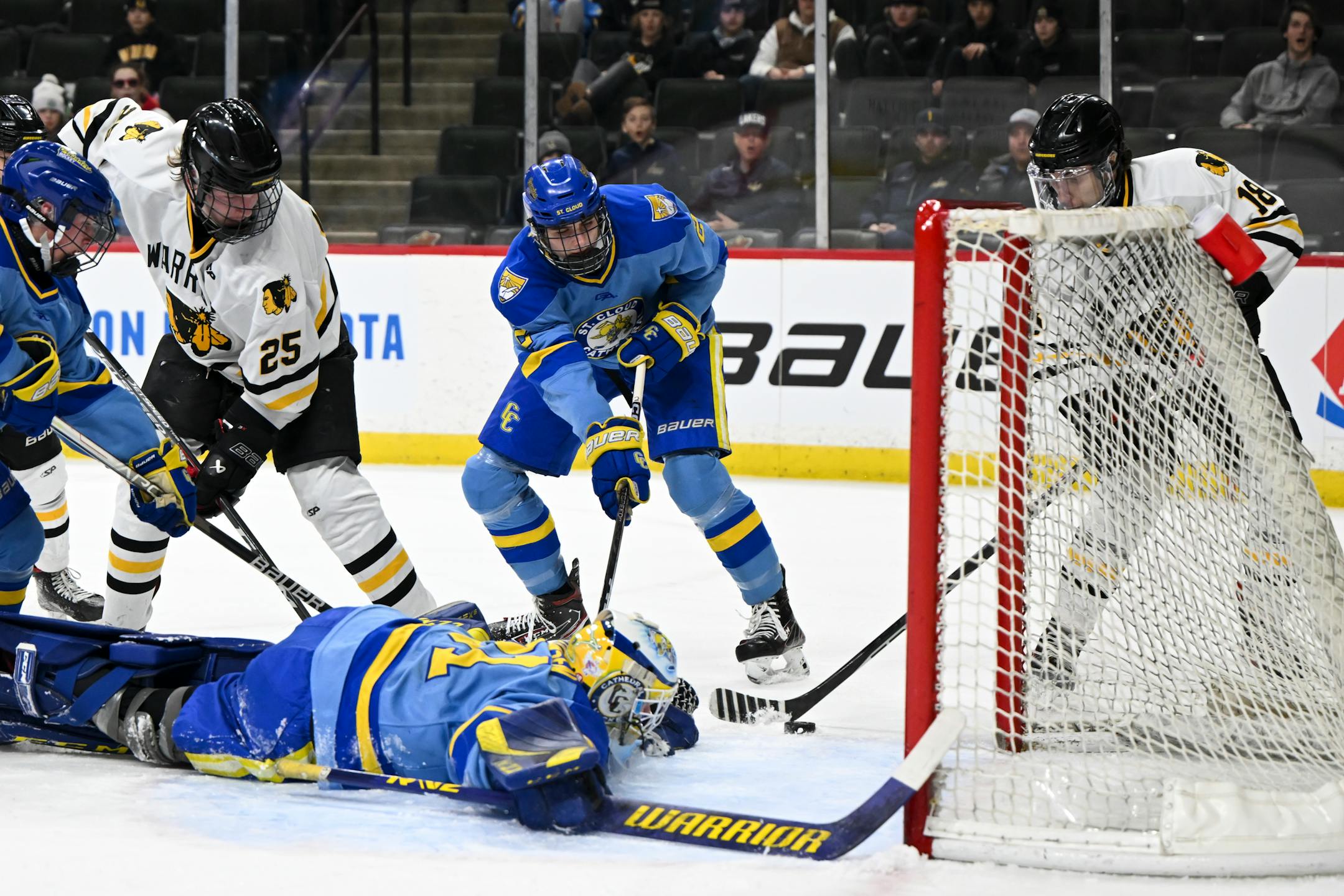 Warroad forward Carson Pilgrim (18) scores a goal against St. Cloud Cathedral goaltender Nick Hansen (31) during the first period.