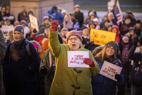 Julie Tholen of St. Paul chants during at a protest in support of Special Counsel Robert Mueller's investigation.