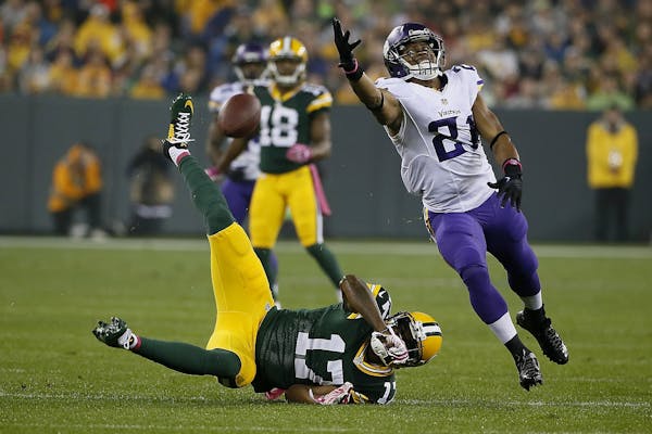 Minnesota Vikings cornerback Josh Robinson (21) broke up a pass meant for Green Bay Packers wide receiver Davante Adams (17) in the first quarter as t