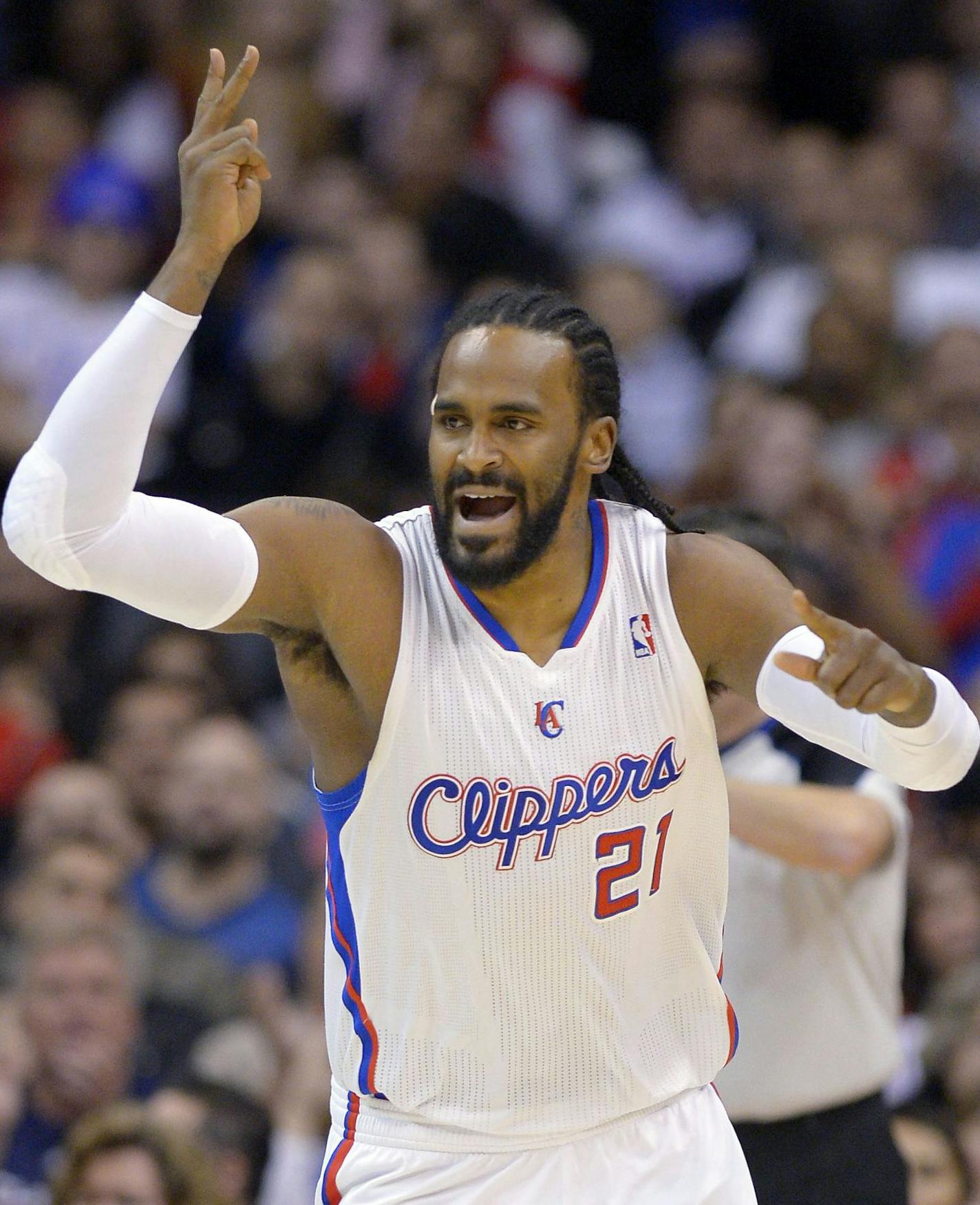 In this Jan. 27, 2013, photo, Los Angeles Clippers' Ronny Turiaf gestures during the Clippers' NBA basketball game against the Portland Trail Blazers in Los Angeles. The Minnesota Timberwolves and Turiaf have agreed to a two-year, $3.2 million contract. Turiaf's agent, Mark Bartelstein, confirmed the deal in a phone interview on Thursday night, July 11, 2013. Bartelstein said Turiaf was encouraged by the direction of the franchise under new boss Flip Saunders and excited by the style of play use