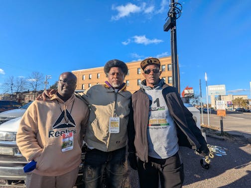 ____, _____, and Larry McPherson stand outside Kimball Court apartments while monitoring crime in the area as part of the organization 21 Days of Peace.