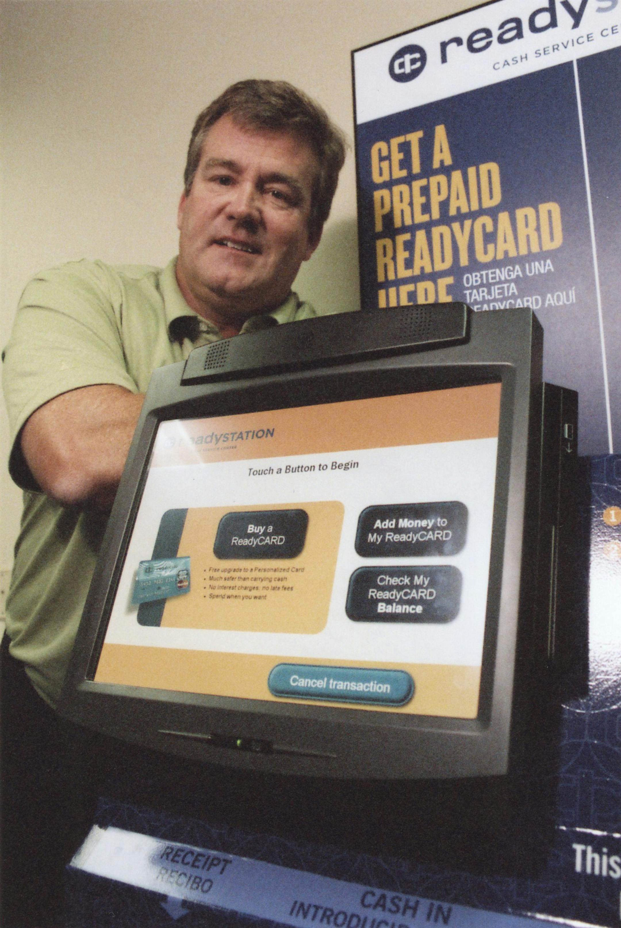 Tim Walsh, CEO of ready credit corp., displays one of the company's self-service kiosks, which offers prepaid master cards and bill-paying services to people who do not have bank accounts.