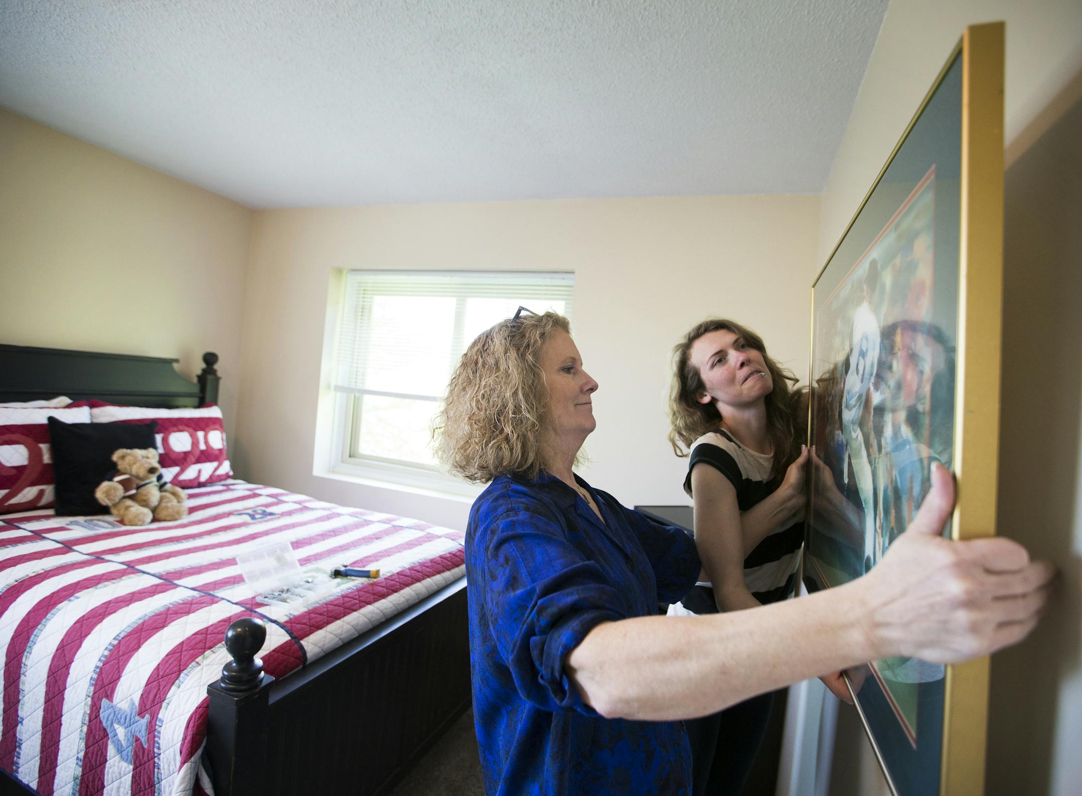 Anita Rockwell, left, and her daughter Casey Rockwell of StageWorks stage a home that will go on the market the next day in Lakeville. ] (Leila Navidi/Star Tribune) leila.navidi@startribune.com BACKGROUND INFORMATION: Tuesday, May 17, 2016 in Lakeville. For Twin Cities home buyers, the spring frenzy continues. With buyers outpacing sellers in many areas, prices increased nearly 8 percent, according to a monthly report released Tuesday morning by the Minneapolis Area Association. Anita Rockwell o