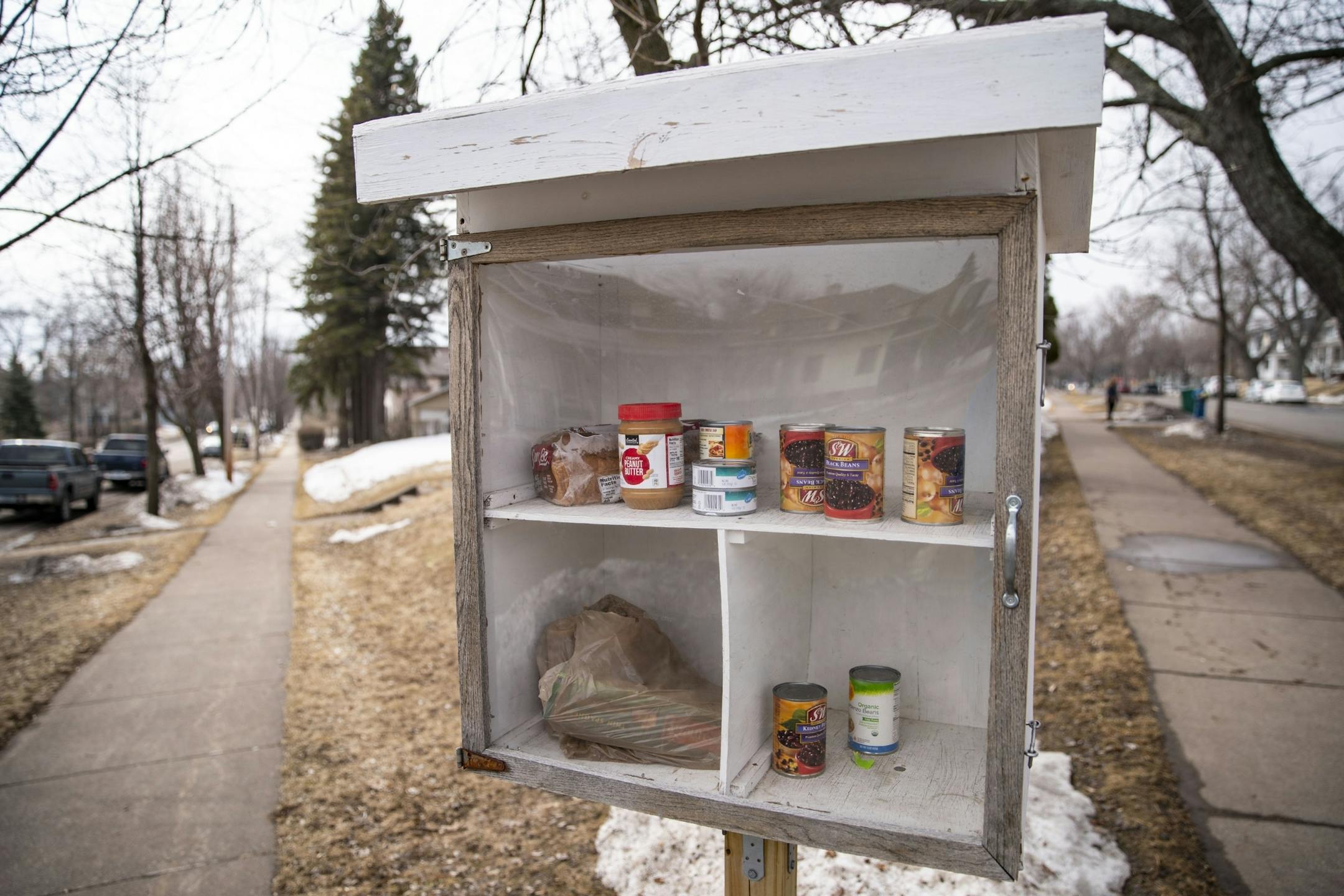A Little Free Library box on the corner of N. Central Ave. and W. 8th St. has been filled with food, including bread, peanut butter, pasta and canned beans in Duluth, MN.