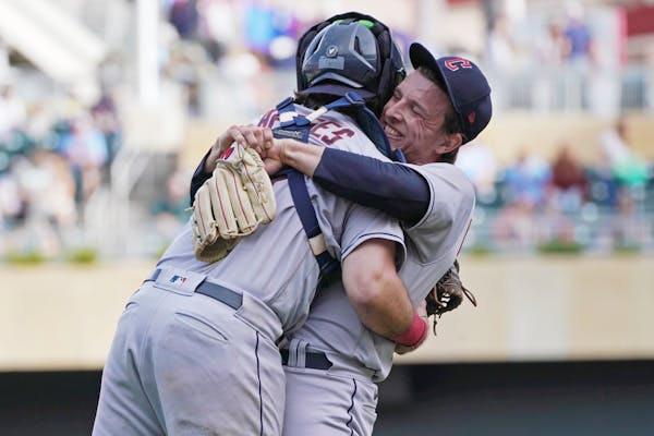 Cleveland Guardians pitcher James Karinchak, right, and catcher Austin Hedges celebrate after they defeated the Twins on Sunday.