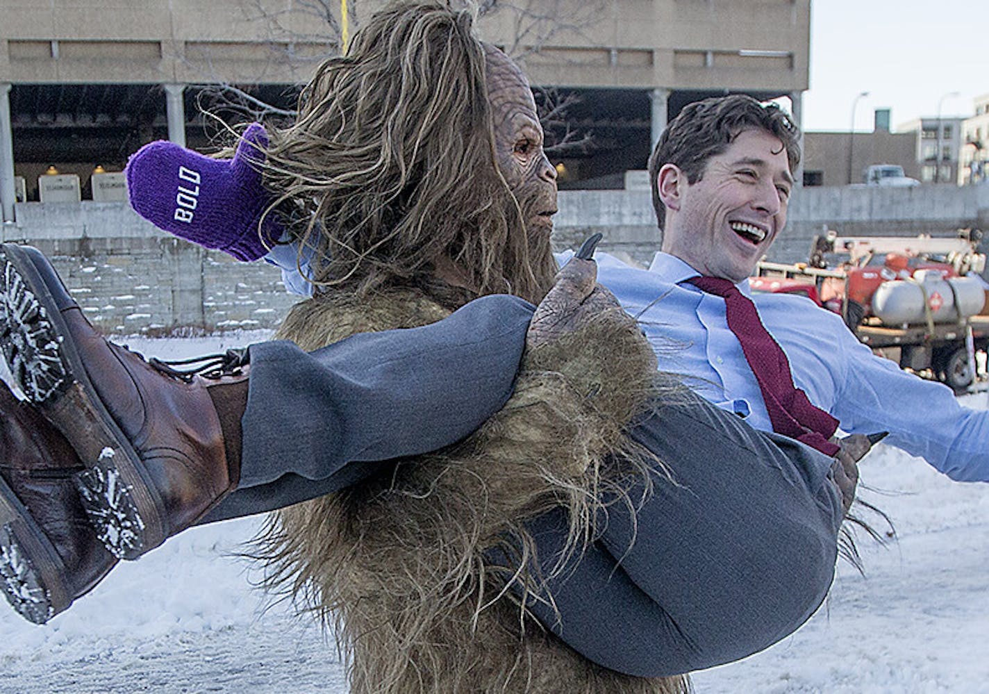 Minneapolis Mayor Jacob Frey was lifted up in celebration by the Jack Link's Jerky Sasquatch after he made his way across the Mississippi River via zip line alongside Viktor the Viking, Friday, January 26, 2018 in Minneapolis, MN. ] ELIZABETH FLORES &#xef; liz.flores@startribune.com