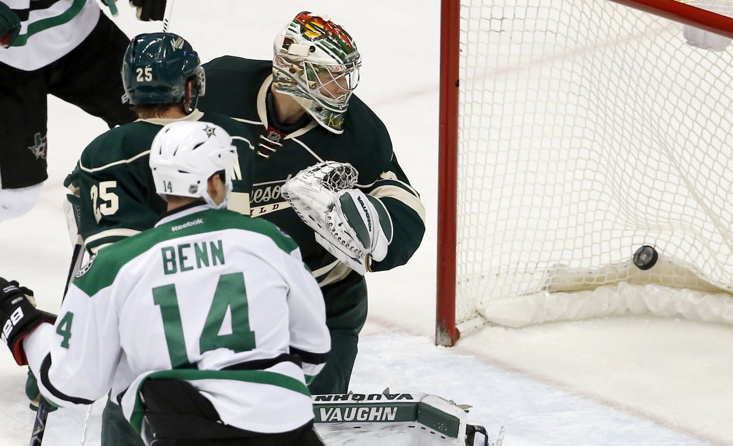 Minnesota Wild goalie Darcy Kuemper, top right, Wild defenseman Jonas Brodin (25), of Sweden, and Dallas Stars left wing Jamie Benn (14) watch as the game-tying shot by Stars defenseman John Klingberg gets past Kuemper during the third period of an NHL hockey game in St. Paul, Minn., Saturday, Nov. 28, 2015. The Stars won 4-3 in overtime. (AP Photo/Ann Heisenfelt)