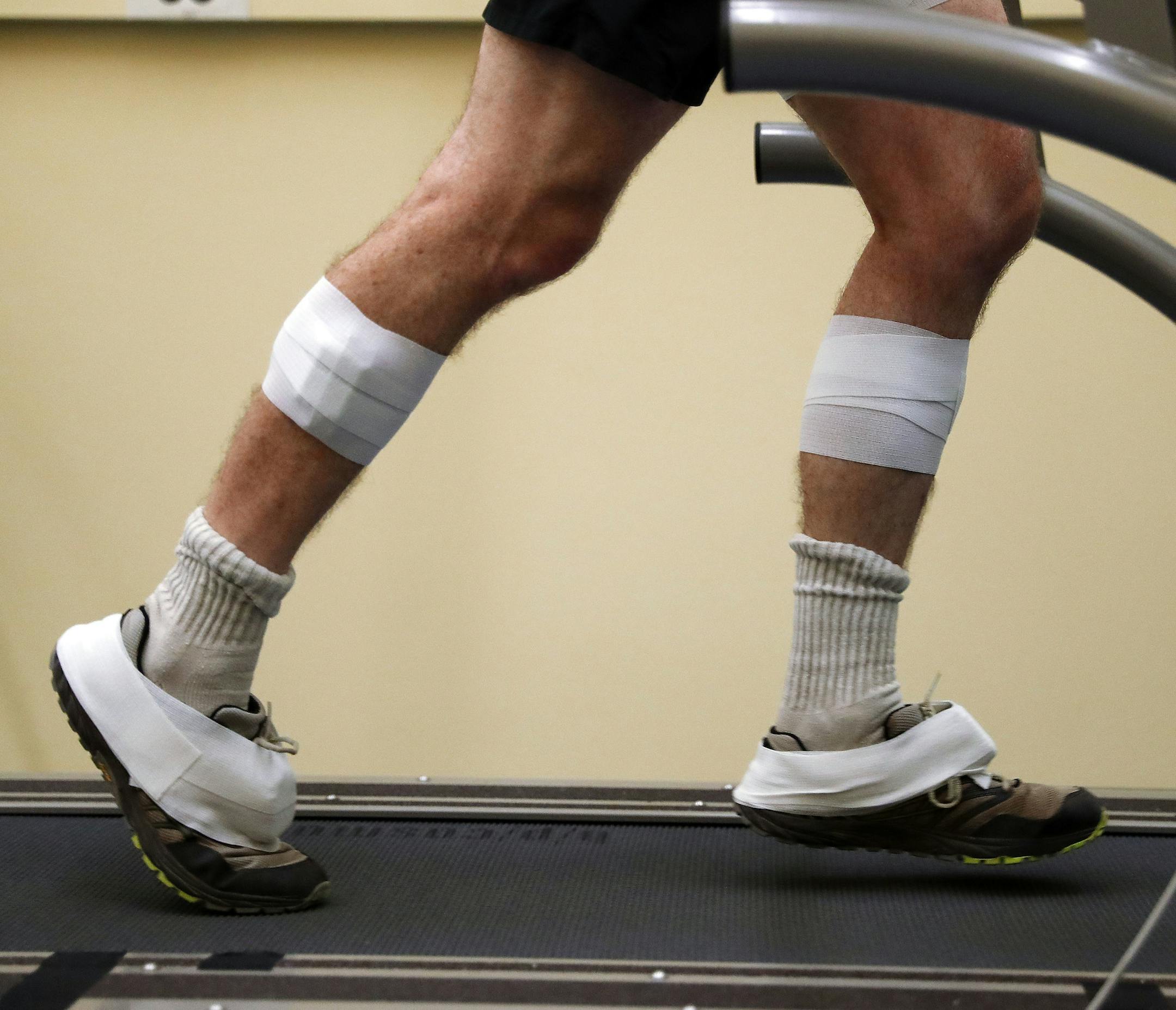 In this Friday, Aug. 12, 2016 photo, sensors are shown taped to the legs and feet of David Moran as he runs on a treadmill in Ann Arbor, Mich. A University of Michigan lab, The Michigan Performance Research Laboratory, which is part of the School of Kinesiology, is offering runners an in-depth assessment designed to help them improve their form. The consultations last around two hours and include footwear, musculoskeletal and postural evaluations by a physical therapist as well as footprint pres