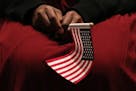 A new U.S. citizen held an American flag during a naturalization ceremony.
