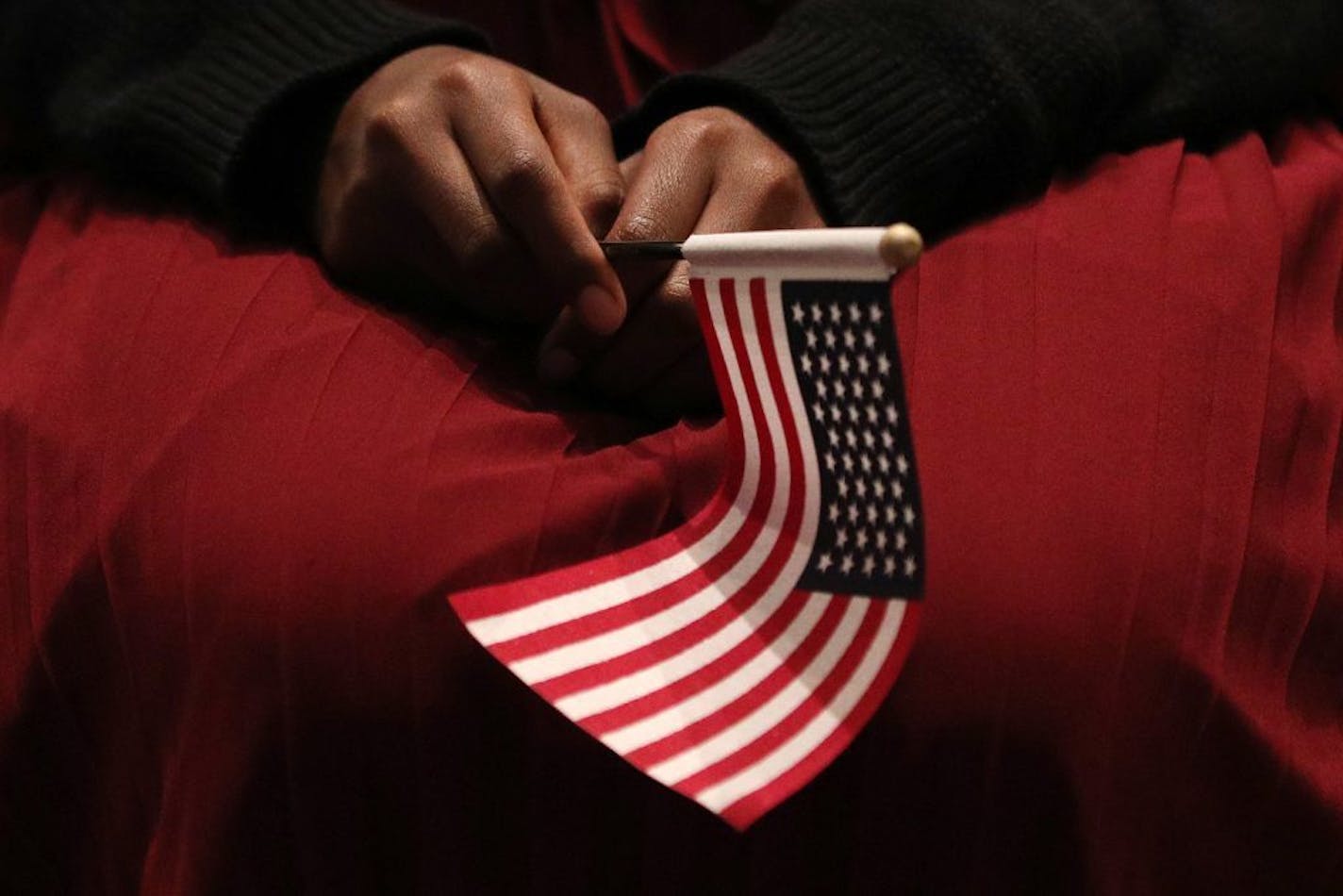 A new U.S. citizen held an American flag during a naturalization ceremony.