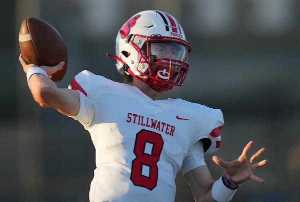 Max Shikenjanski(8) of Stillwater looks for his receiver. Centennial High School football opens at home against Stillwater High School in Circle Pines