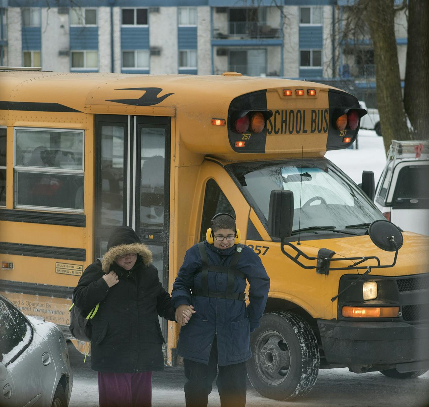 Cora Mustin meet her 15-year-old son Jordan Mustin at his bus stop in front of her apartment Thursday December 14, 2017 in Mounds View, MN. Jordan has autism and a history of violent outbursts toward himself and family.] JERRY HOLT &#xef; jerry.holt@startribune.com