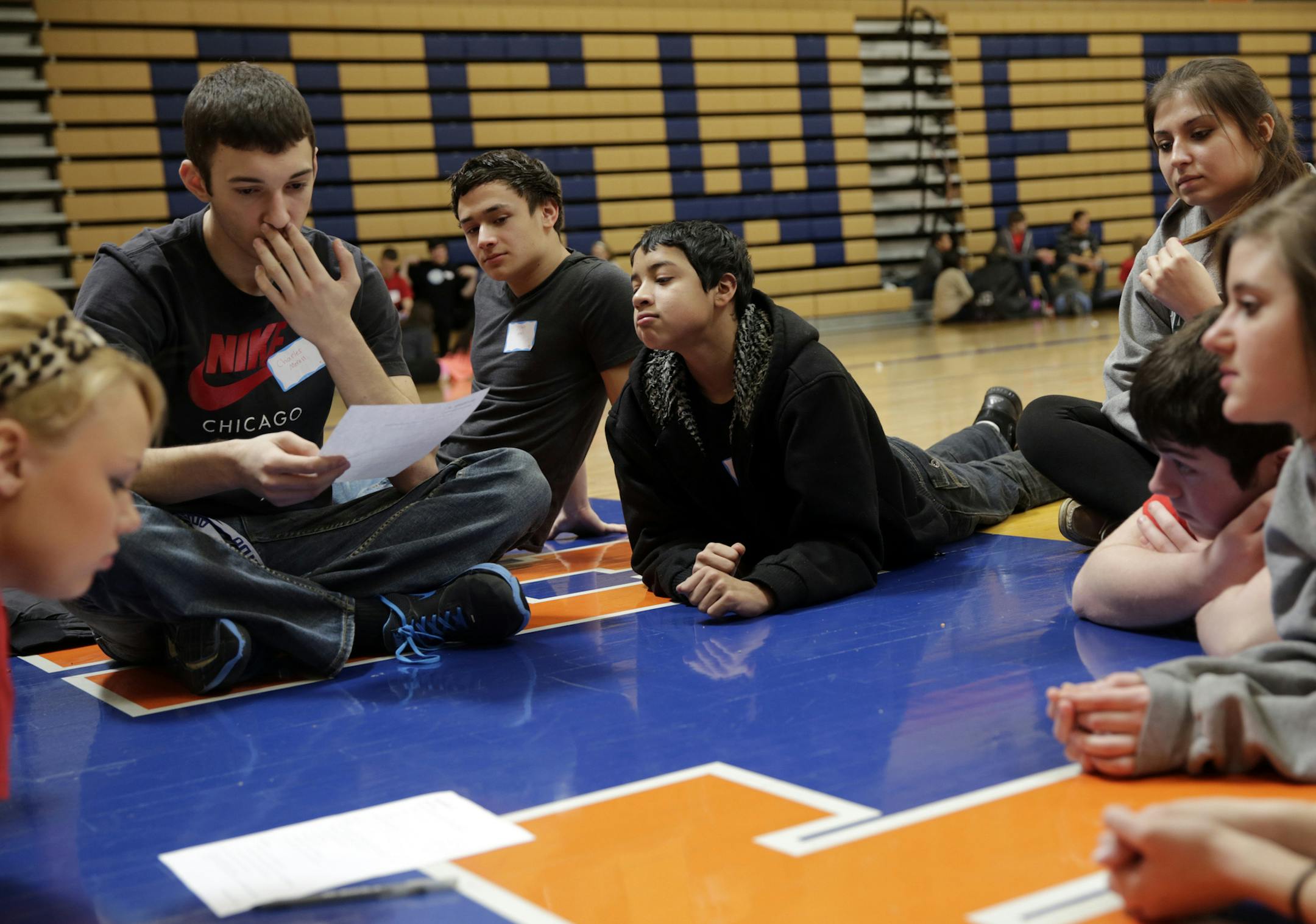 Charles Morrell, 16, from left, Jordan Noel, 17, and Matthew Castillo, 15, join other students to discuss the impact and implications of hazing after Alice Haben spoke about her son Nicolas, who drank himself to death in a hazing ritual at Western Illinois University in 1990, during Oswego High School's Believe It Or Not I Care (BIONIC) club's Teens Activating the Language of Kindness (TALK) session, February 20, 2013, in Oswego, Illinois. (Michael Tercha/Chicago Tribune/MCT) ORG XMIT: 1135644