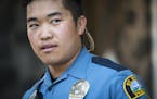 Officer Pheng Xiong looked on while walking his beat along Payne Avenue in St. Paul.