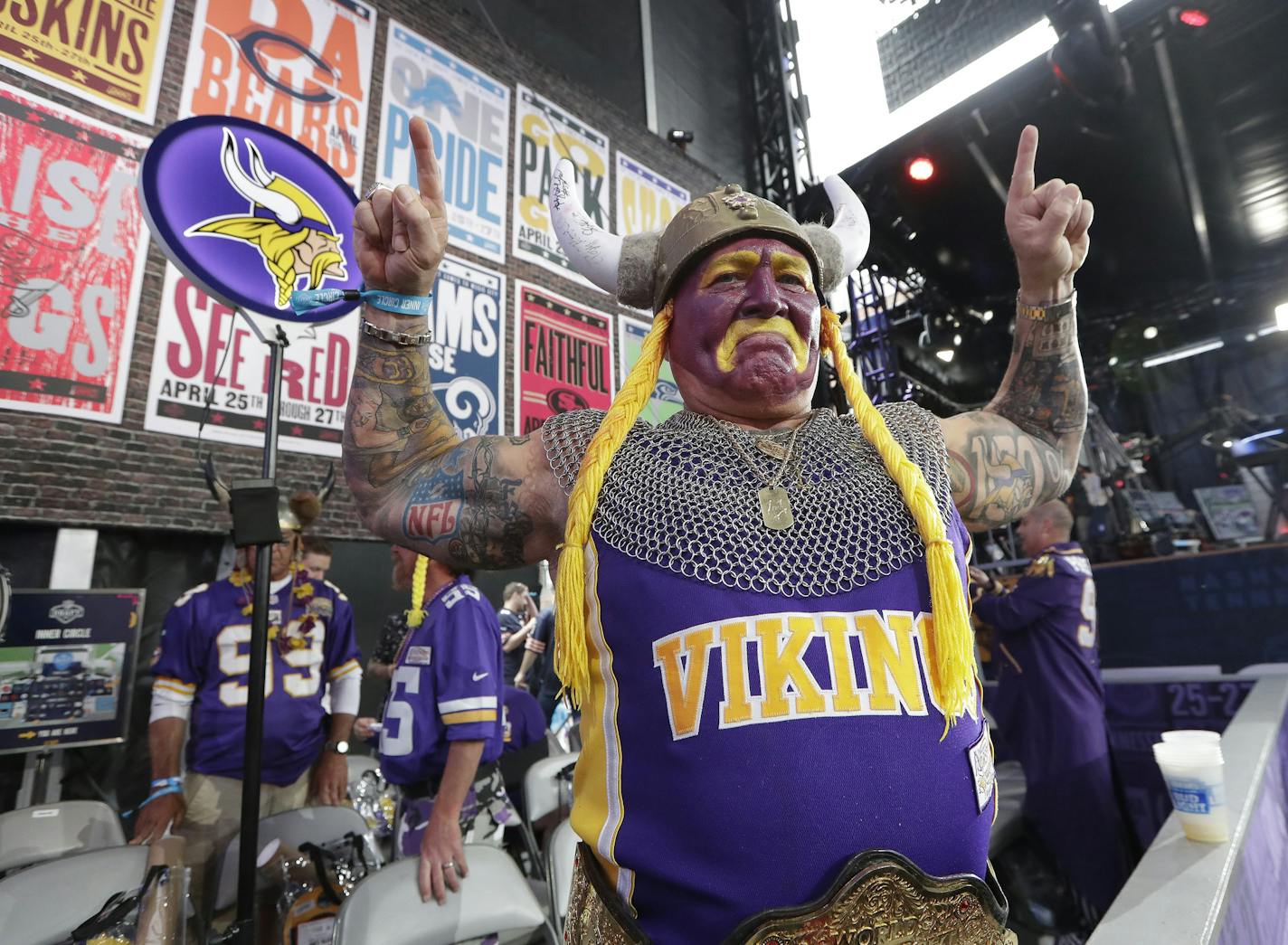 Minnesota Vikings fan Syd Davy cheers ahead of the first round at the NFL football draft, Thursday, April 25, 2019, in Nashville, Tenn. (AP Photo/Mark Humphrey)