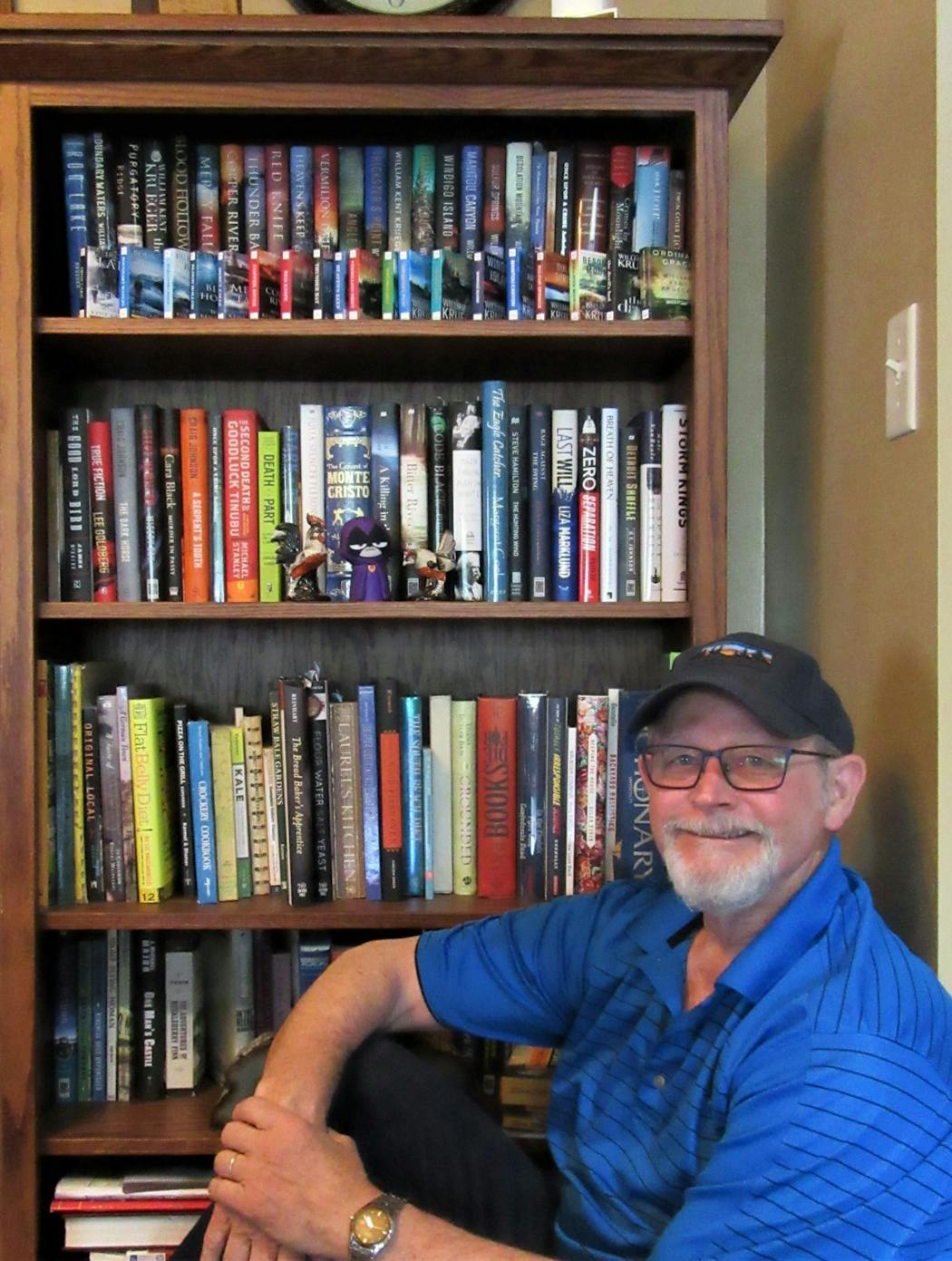 William Kent Krueger and one of his bookcases.