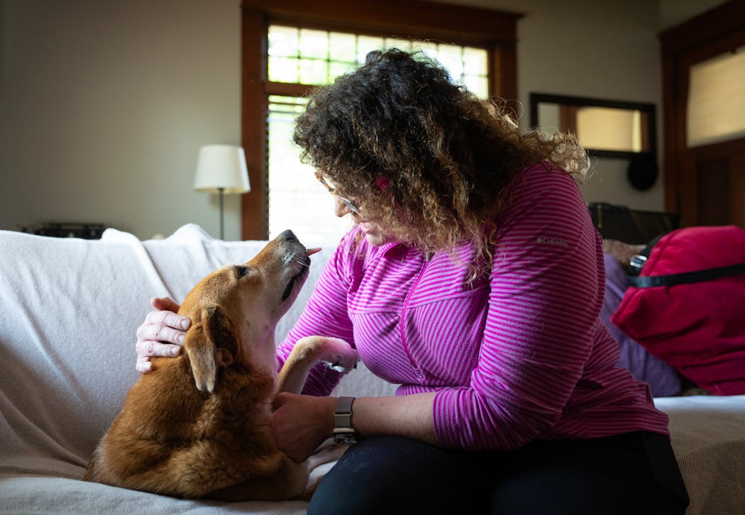 Jenny, a mixed breed rescue dog, meets massage therapist Heidi Hesse.