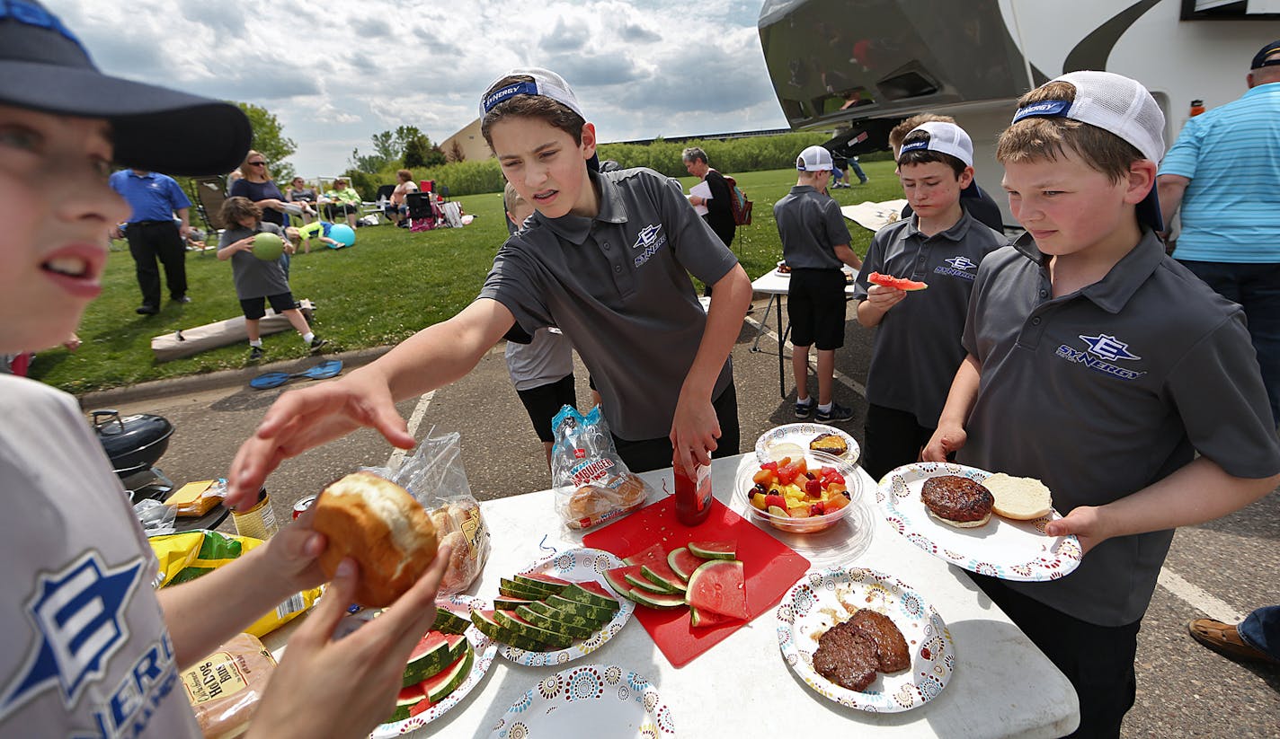 Members of the Easton Synergy AAA hockey team shared a meal amid their families&#x2019; RVs in a parking lot at the Schwan Super Rink.