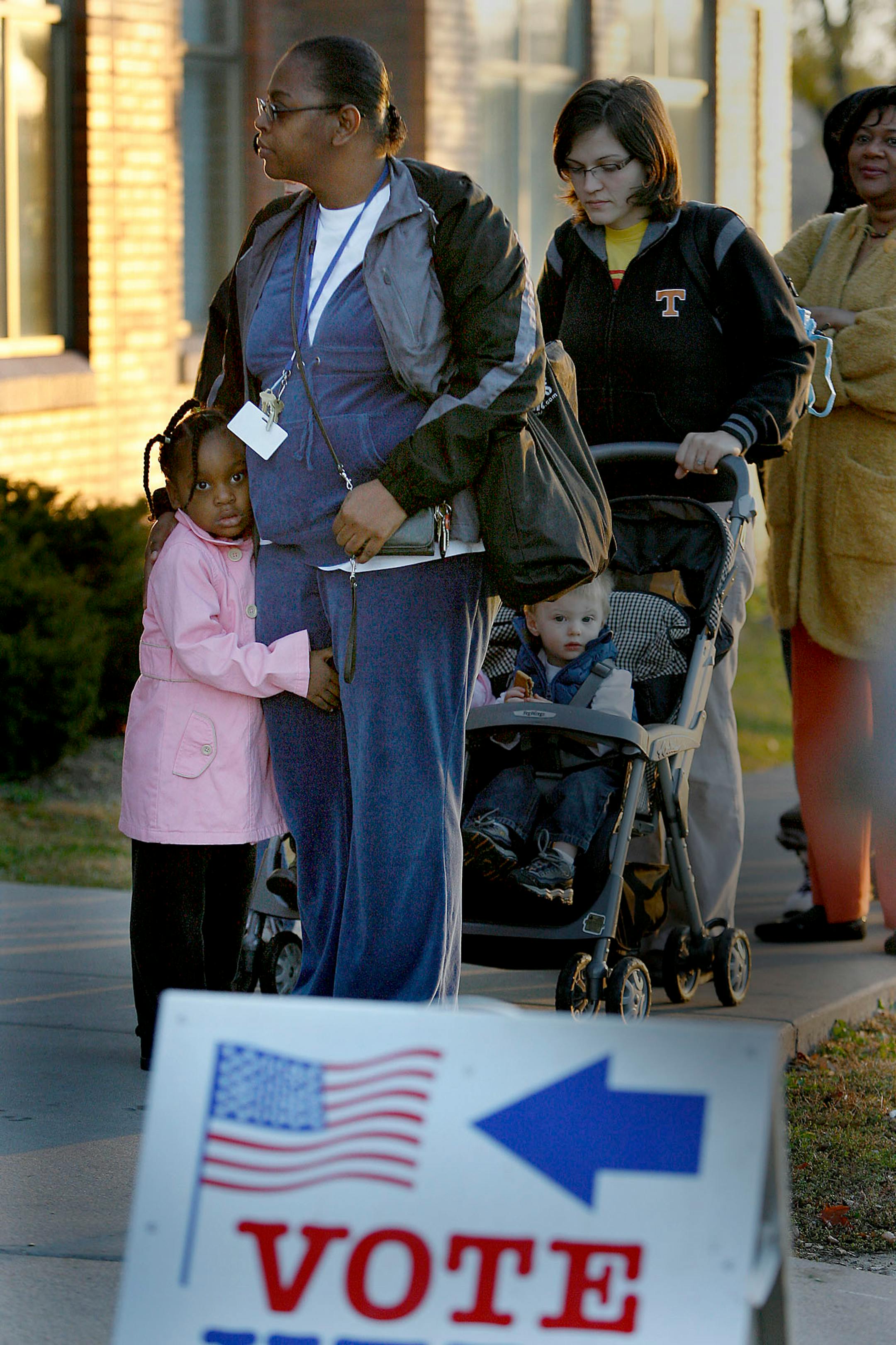 Minutes after the voting booths opened, Bridget Riddley, waited in an early morning line with her daughter Nikayla, 3, at Minneapolis Urban League.