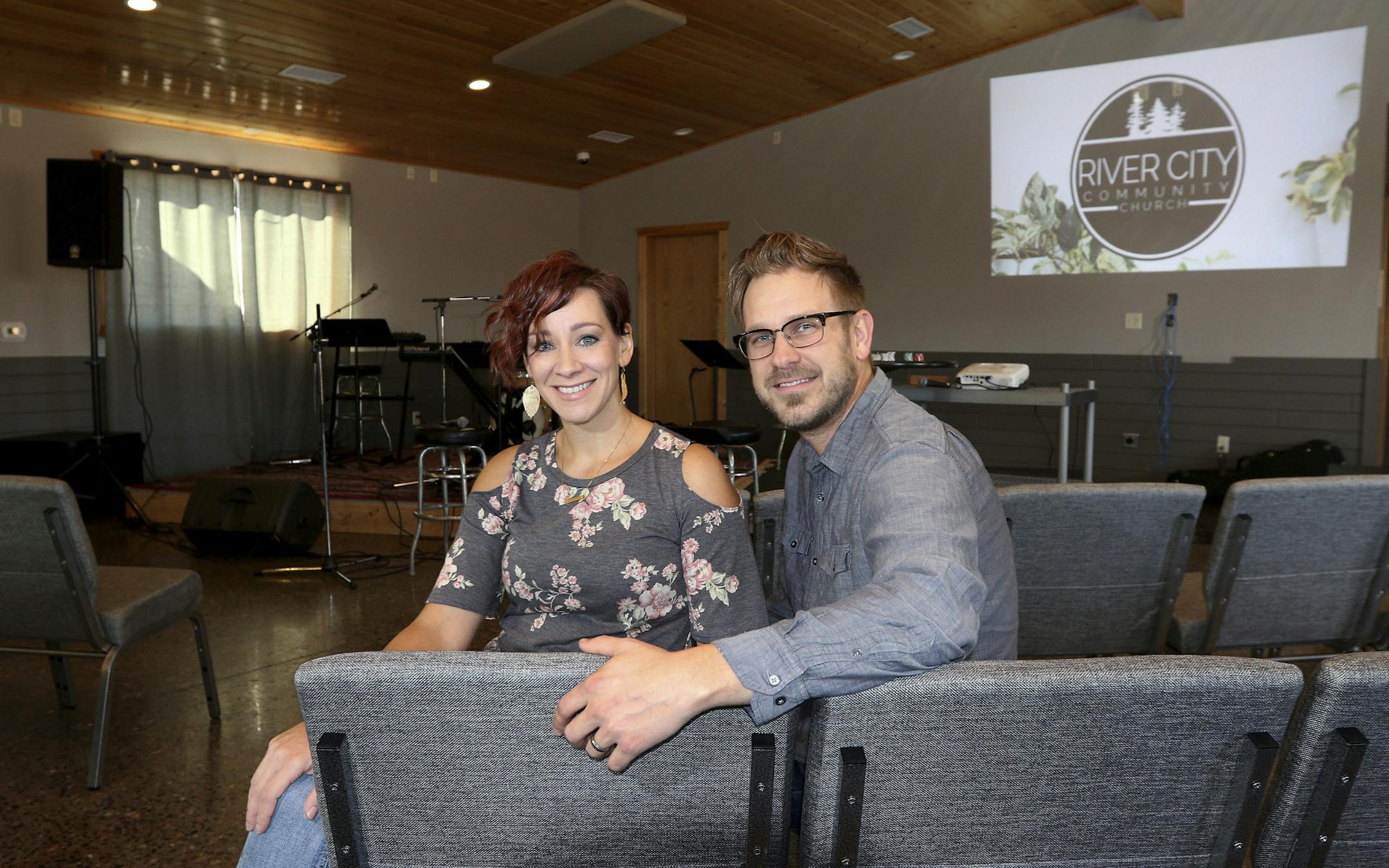 In this Thursday, Nov. 1, 2018, photo, Chris and Jaci Uttecht pose for a photo inside a new church they started called River City Community Church in Chippewa Falls, Wis., which is located in what was formerly The Lodge tavern. (Dan Reiland/The Eau Claire Leader-Telegram via AP)