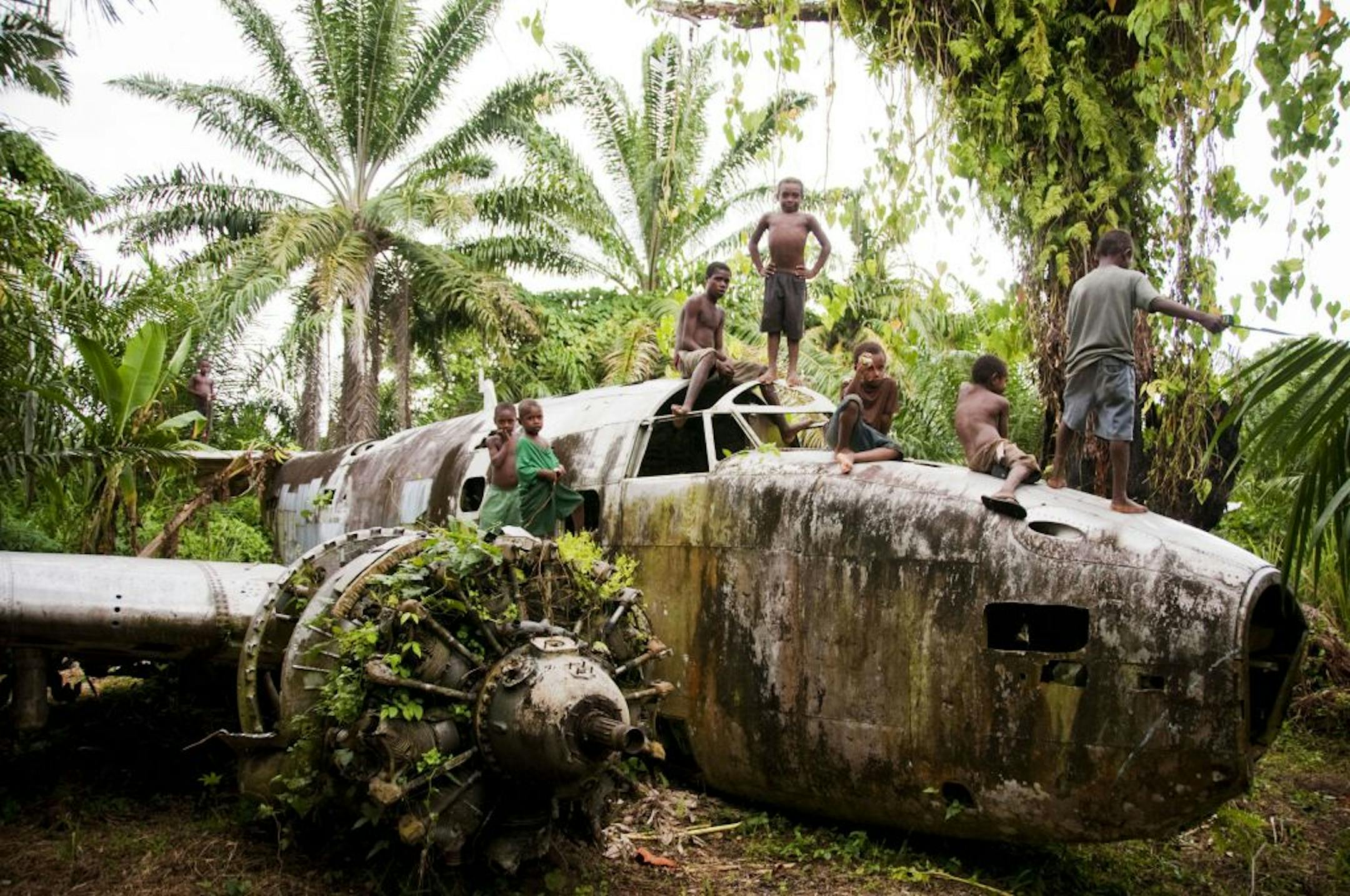 Rich Koechlein of Minneapolis encountered the wreckage of a World War II bomber serving as a playground for boys on Papau New Guinea's New Britain Island.