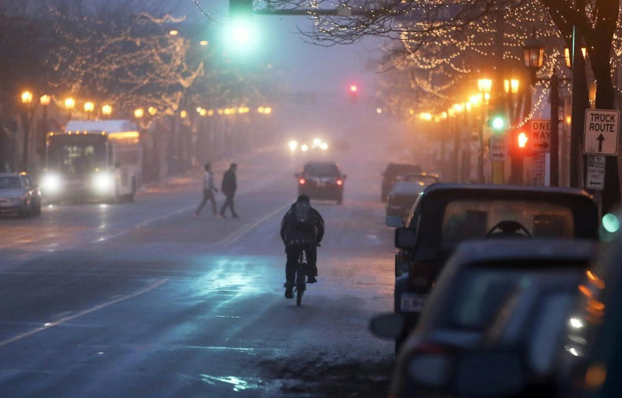 Bicyclists, pedestrians and motorists navigated light fog Tuesday, Dec. 3, 2013, in Minneapolis on Nicollet Ave. S. and 26th Street.