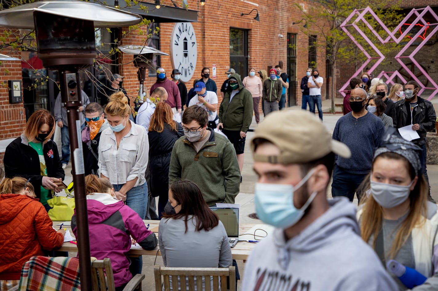 A line formed as people checked in for a Covid-19 vaccine shot at Lake Monster Brewing in St. Paul. The brewery held the event which promoted a free beer coupon after getting the vaccine.