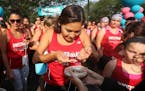 Women, mostly Native American, stood in line to smudge sage before completing the 2015 KWESTRONG women's triathlon, Saturday, August 22, 2015 in Minne