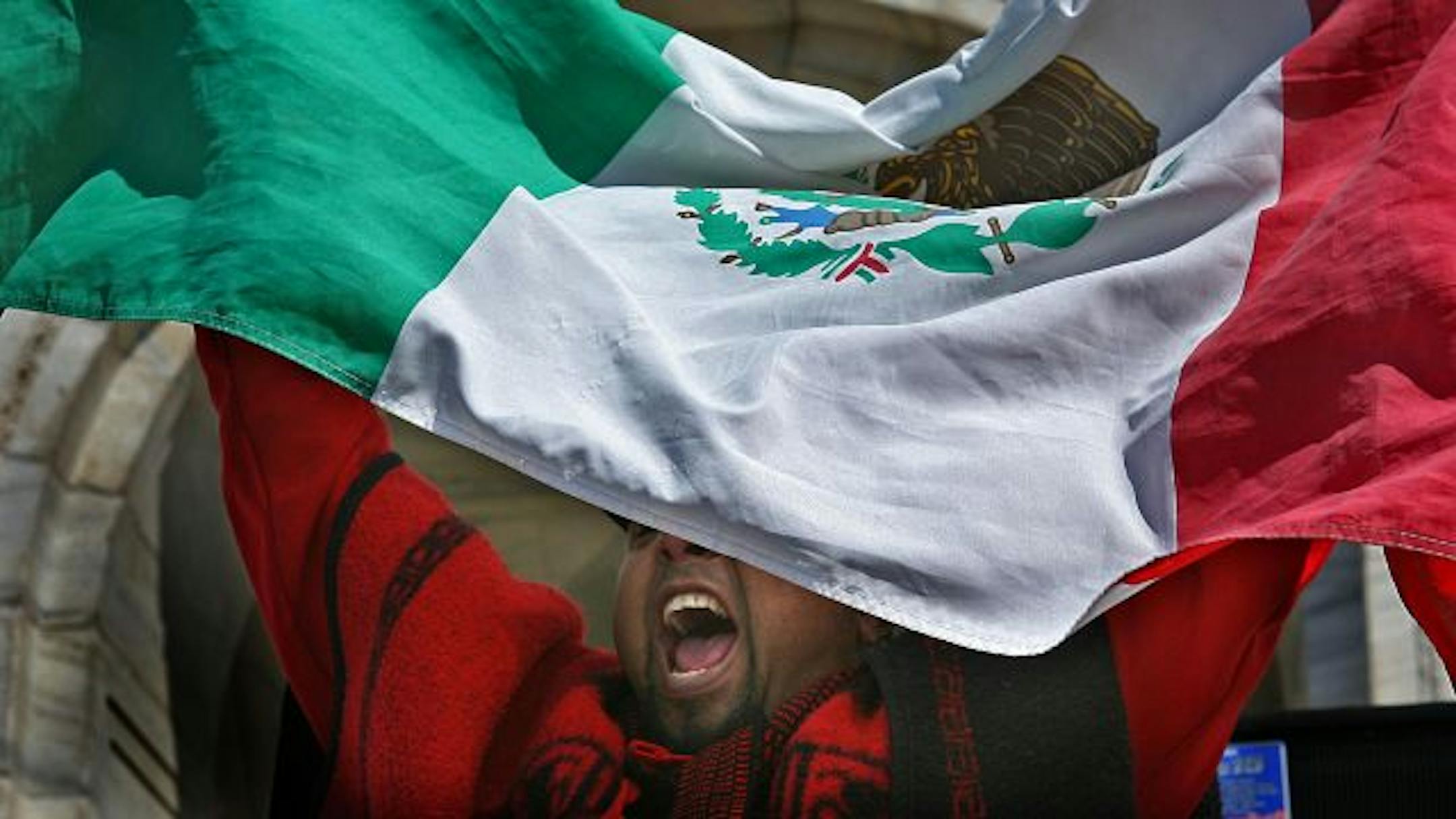JIM GEHRZ � jgehrz@startribune.com St. Paul/April 21, 2009/10:00AM Jesus Ramirez shouted enthusiastically from beneath a Mexican flag as he participated in the 5th Annual Student Day at the Minnesota state Capitol. More than 500 immigrant students and educators from the area gathered to promote affordable education for all Minnesotans. Ramirez teaches environmental science at the Multicultural Indigenous Academy in St. Paul.