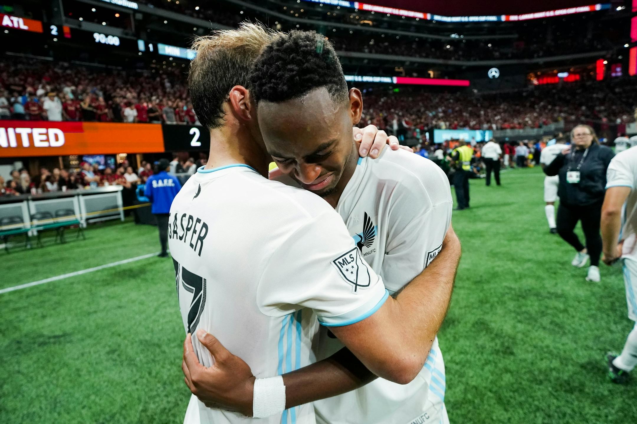 Minnesota United defender Chase Gasper (77) comforts forward Mason Toye (23) after losing 2-0 to Atlanta United in the U.S. Open Cup at Mercedes-Benz Stadium in Atlanta on Tuesday, Aug. 27, 2019. Photo by Kevin D. Liles for the Star Tribune