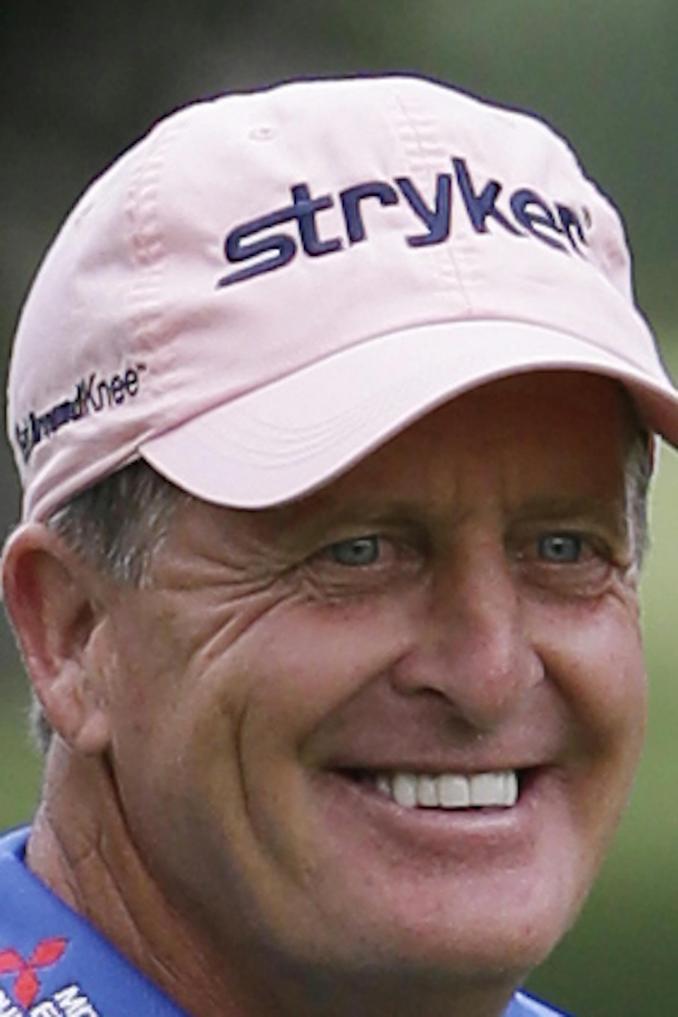 Fred Funk smiles as he walks on the first green during the first round of the Encompass Championship golf tournament in Glenview, Ill., Friday, June 20, 2014. (AP Photo/Nam Y. Huh)