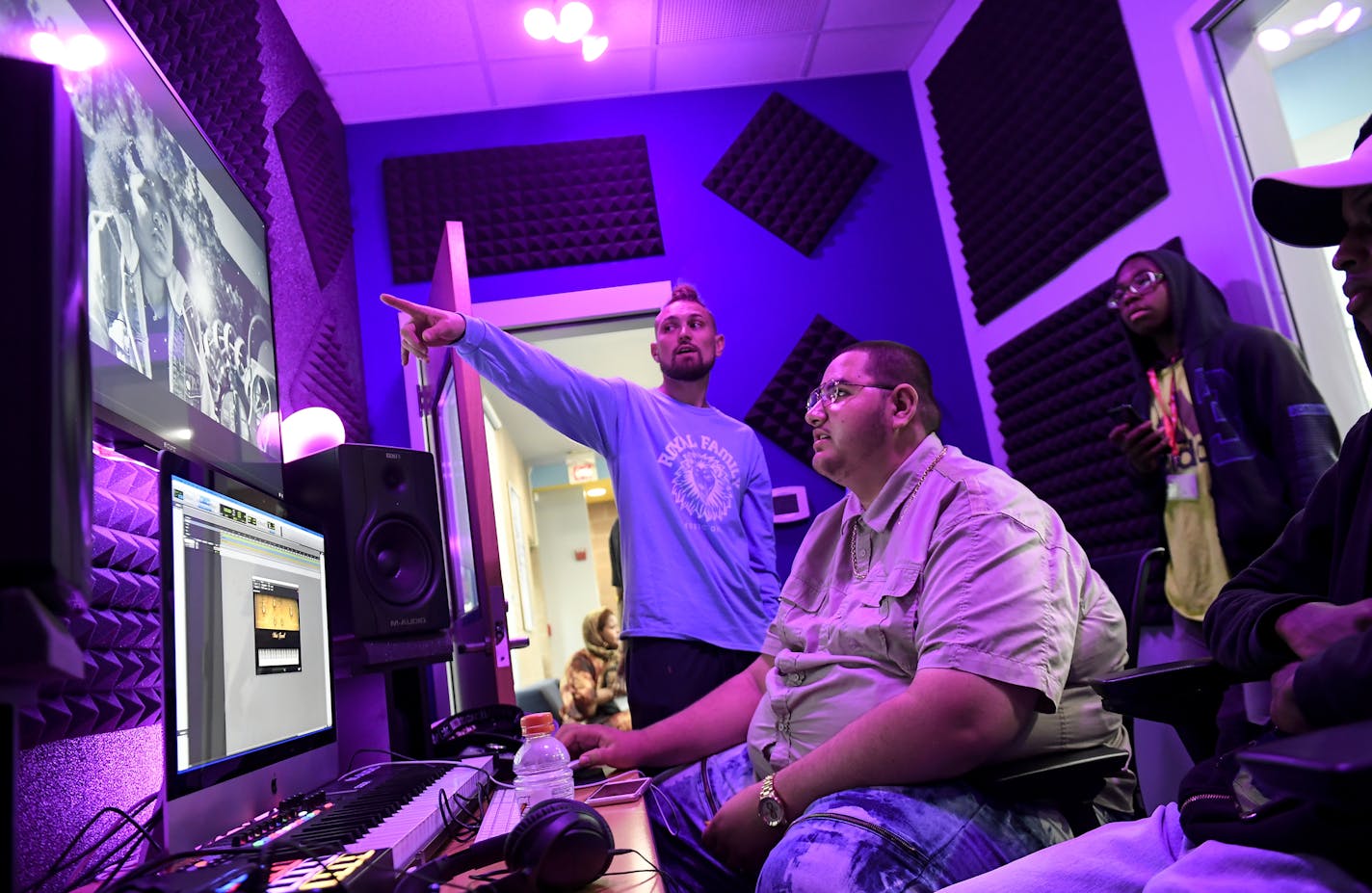 Best Buy Teen Tech Center coordinator, J.T. Evans, center, talked to a few of the students at the center Thursday. They included, from left, Victor Bustamante, 18, Calvin Miller, 14, and Abdalla Nooh, 17. ] Aaron Lavinsky &#xa5; aaron.lavinsky@startribune.com At Hope Community in the Phillips neighborhood students are given the opportunity to use high-end computers and technology equipments to complete student-led projects some of which have gone on to win national awards. We photograph the Best